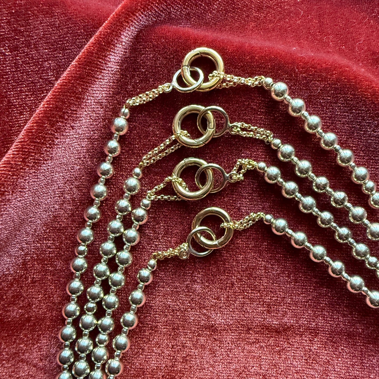 group of gold-filled beaded necklaces