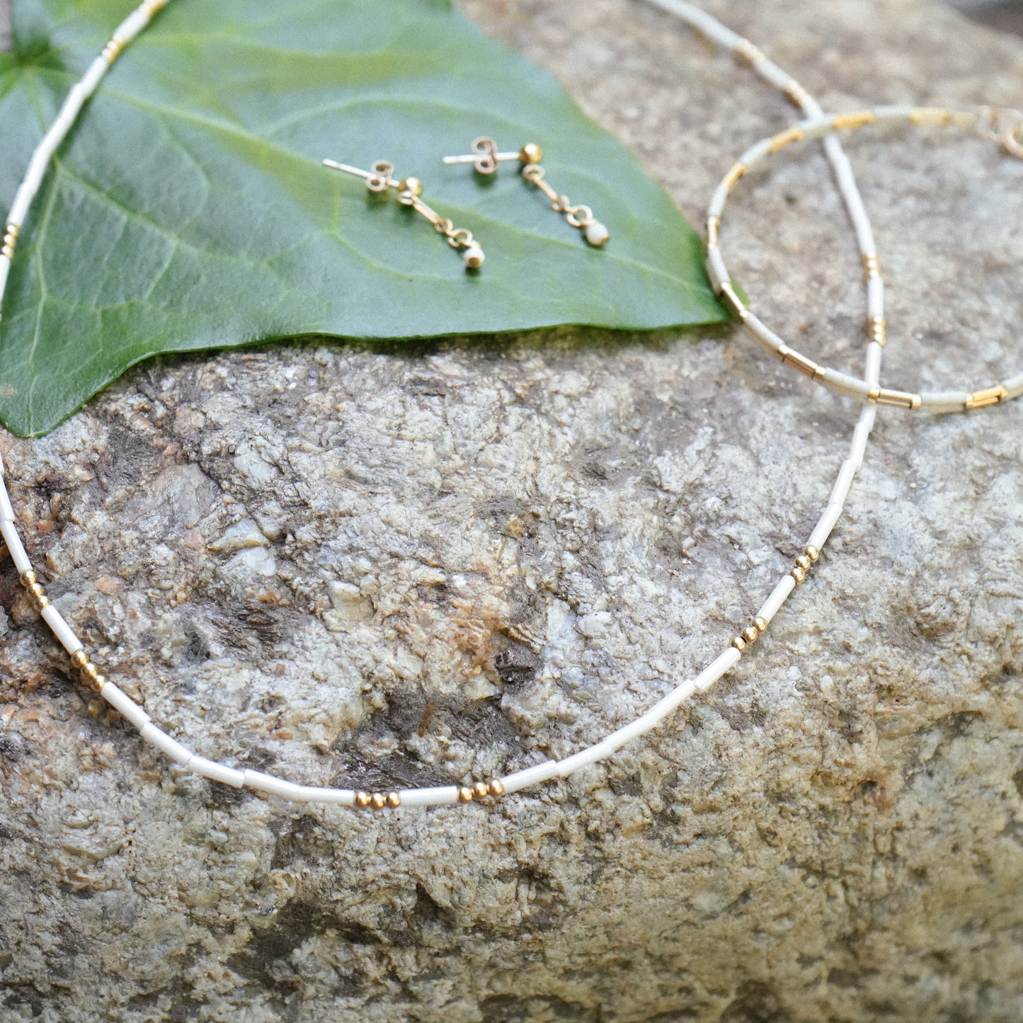 white beaded necklace with matching bracelet and earrings