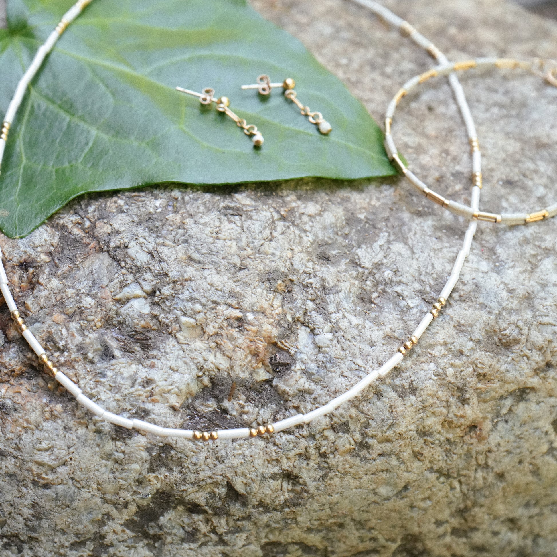 white beaded necklace with matching bracelet and earrings