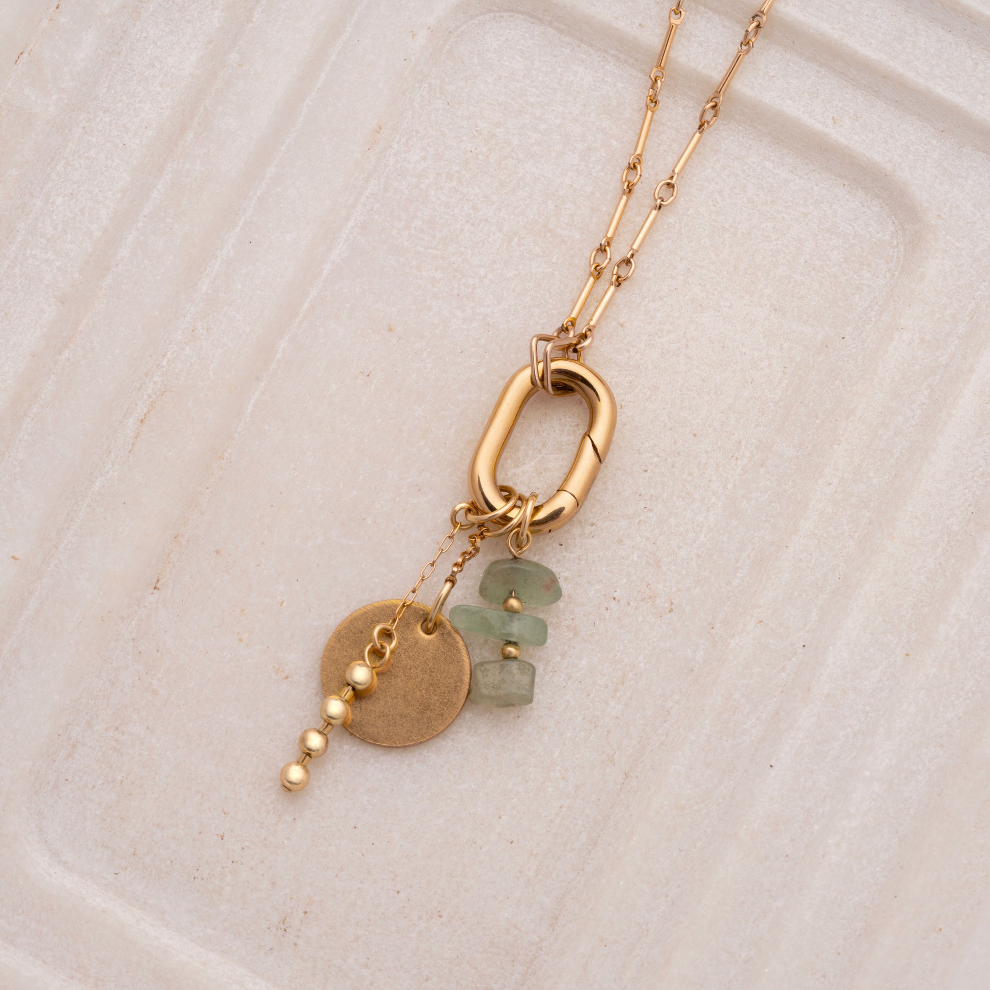 close-up view of charms and stylish clasp on a gold-filled necklace