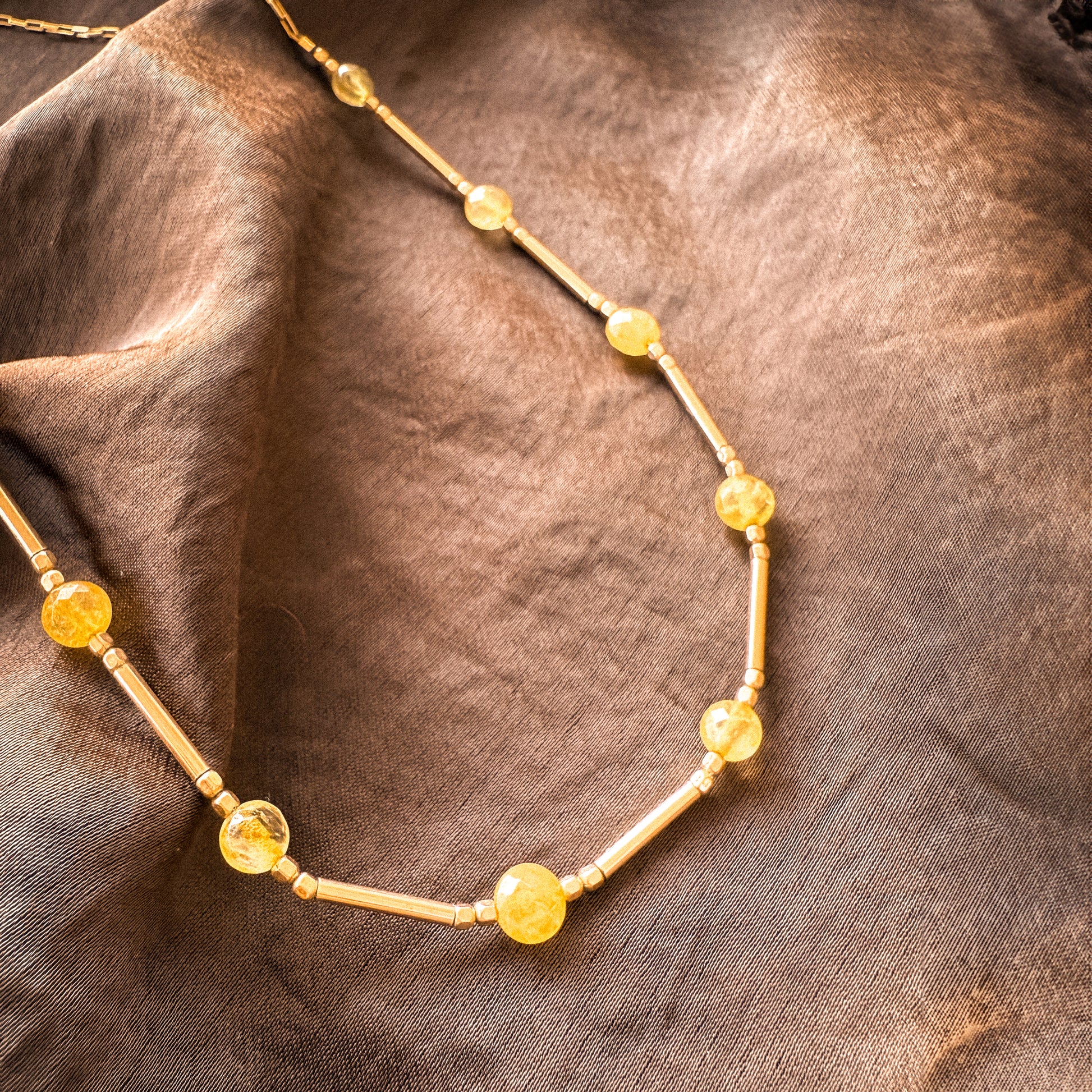 close-up view of citrine and gold-filled beads on a necklace