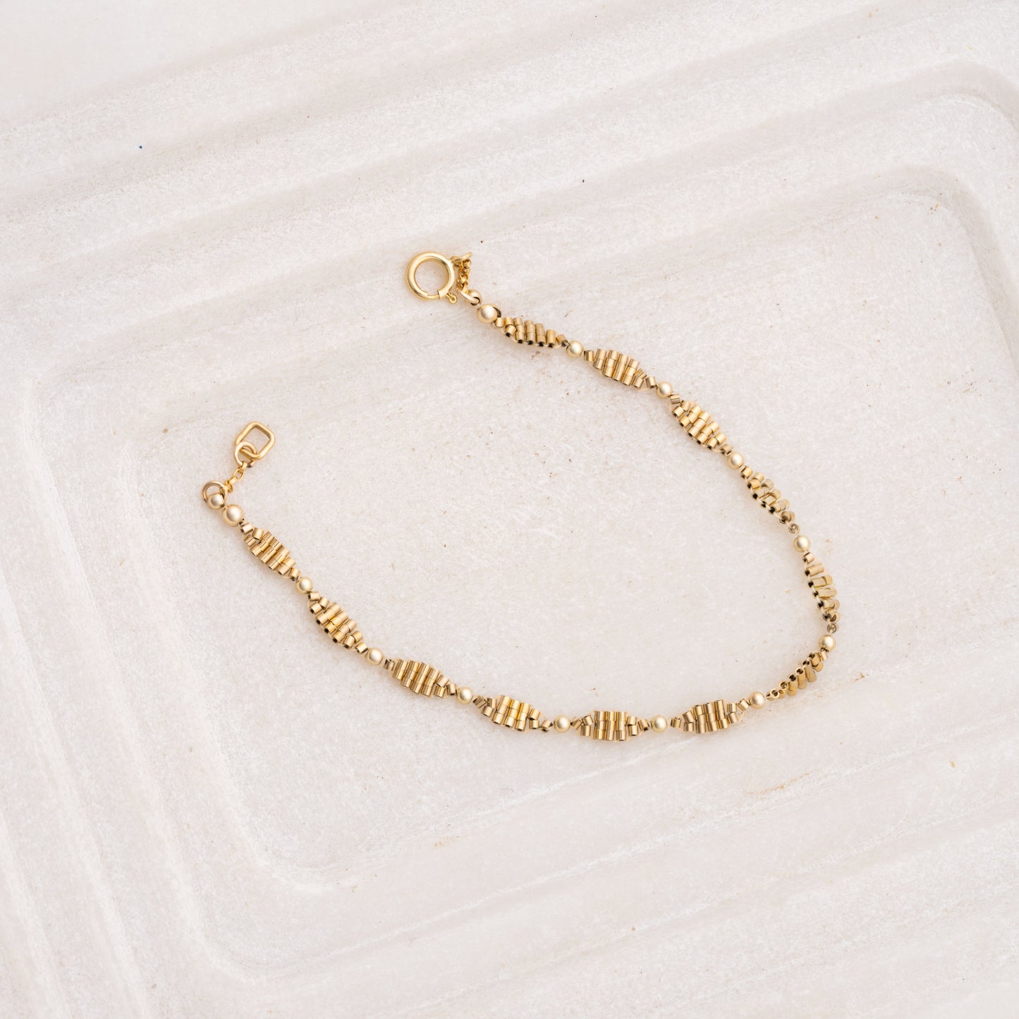 hand-beaded gold-filled bracelet with likeness to a double-helix pattern