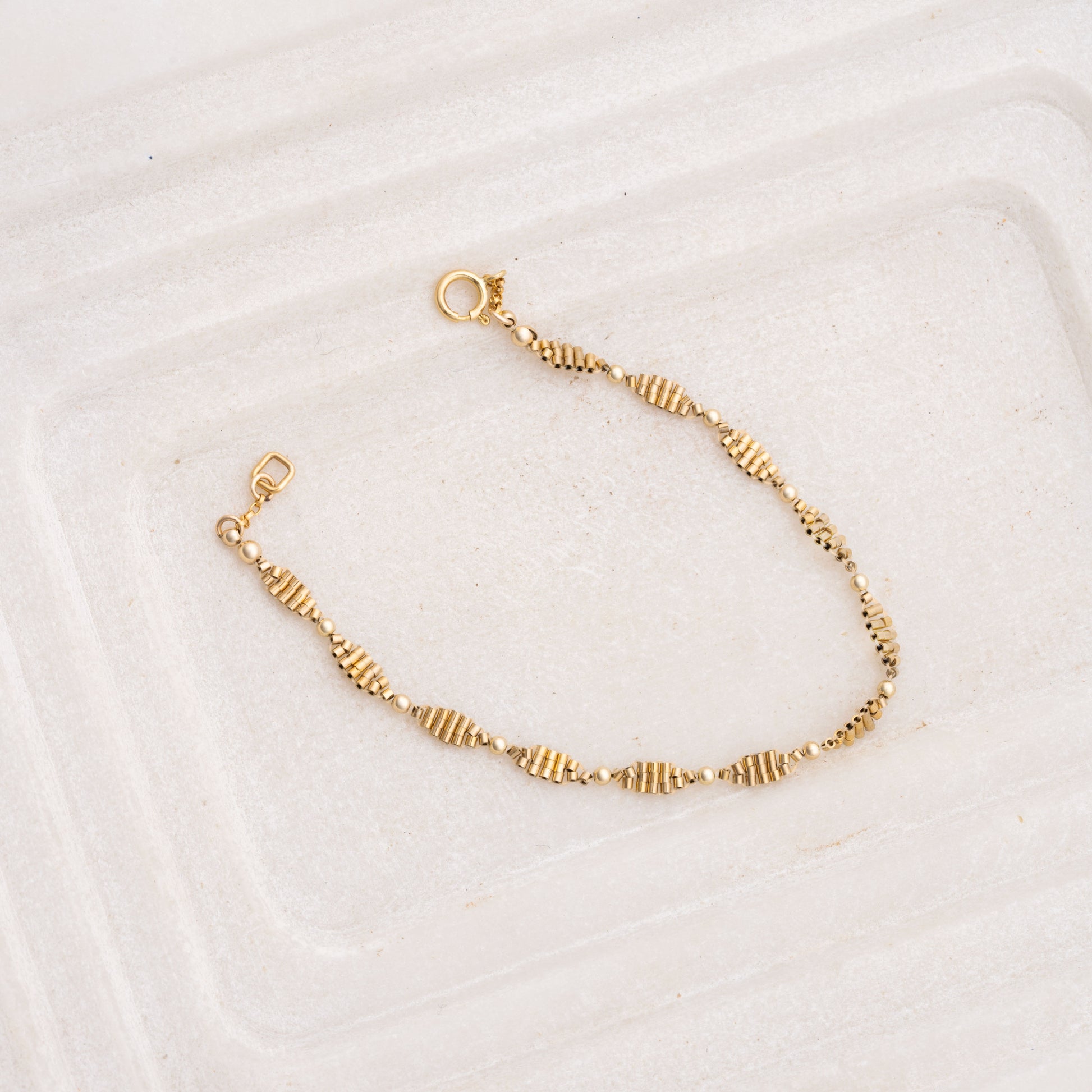hand-beaded gold-filled bracelet with likeness to a double-helix pattern