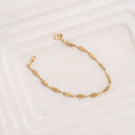 hand-beaded gold-filled bracelet with likeness to a double-helix pattern