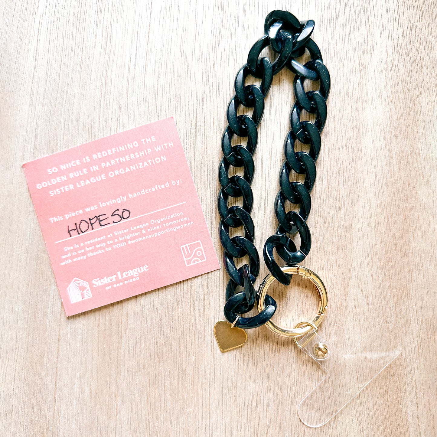 tag showing the maker of a black acrylic link phone bracelet