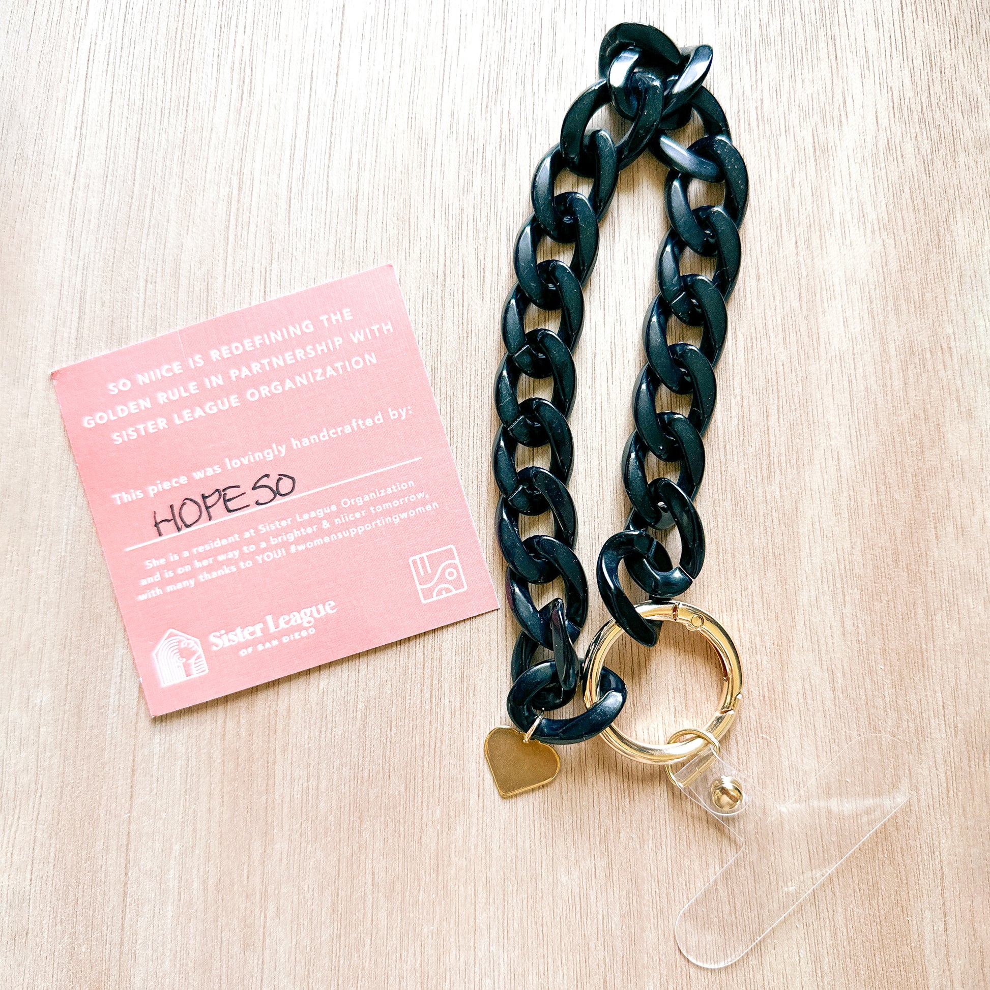 tag showing the maker of a black acrylic link phone bracelet