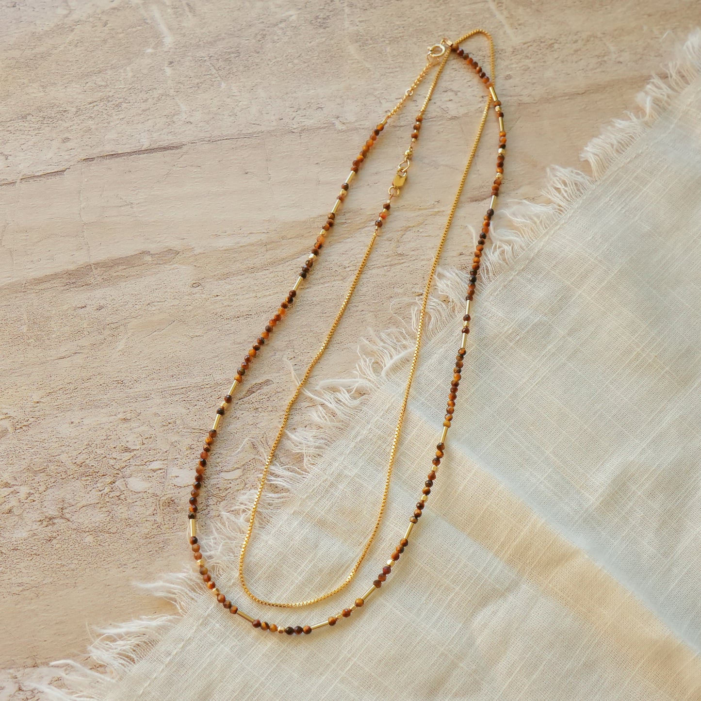 bundle of a necklace with tiger's eye beads and a gold-chain necklace with tiger's eye bead accents