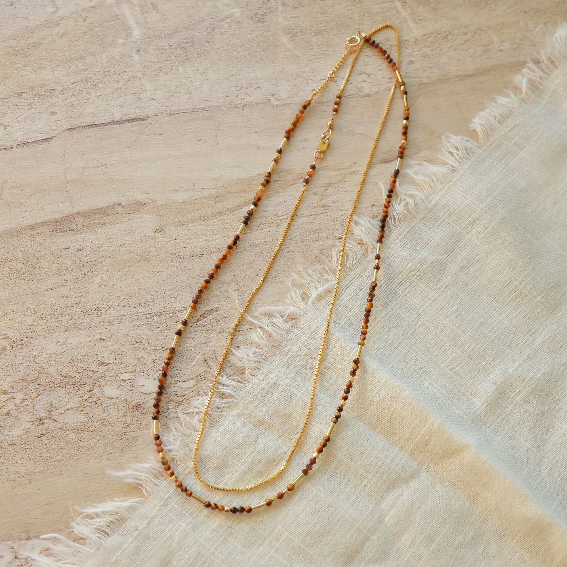 bundle of a necklace with tiger's eye beads and a gold-chain necklace with tiger's eye bead accents