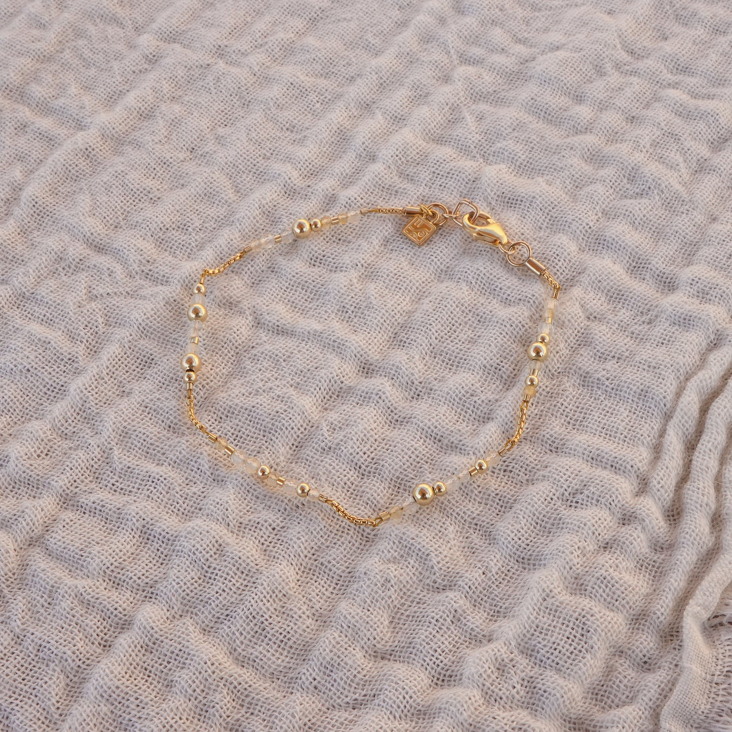 citrine and gold-filled beaded bracelet on a white linen cloth
