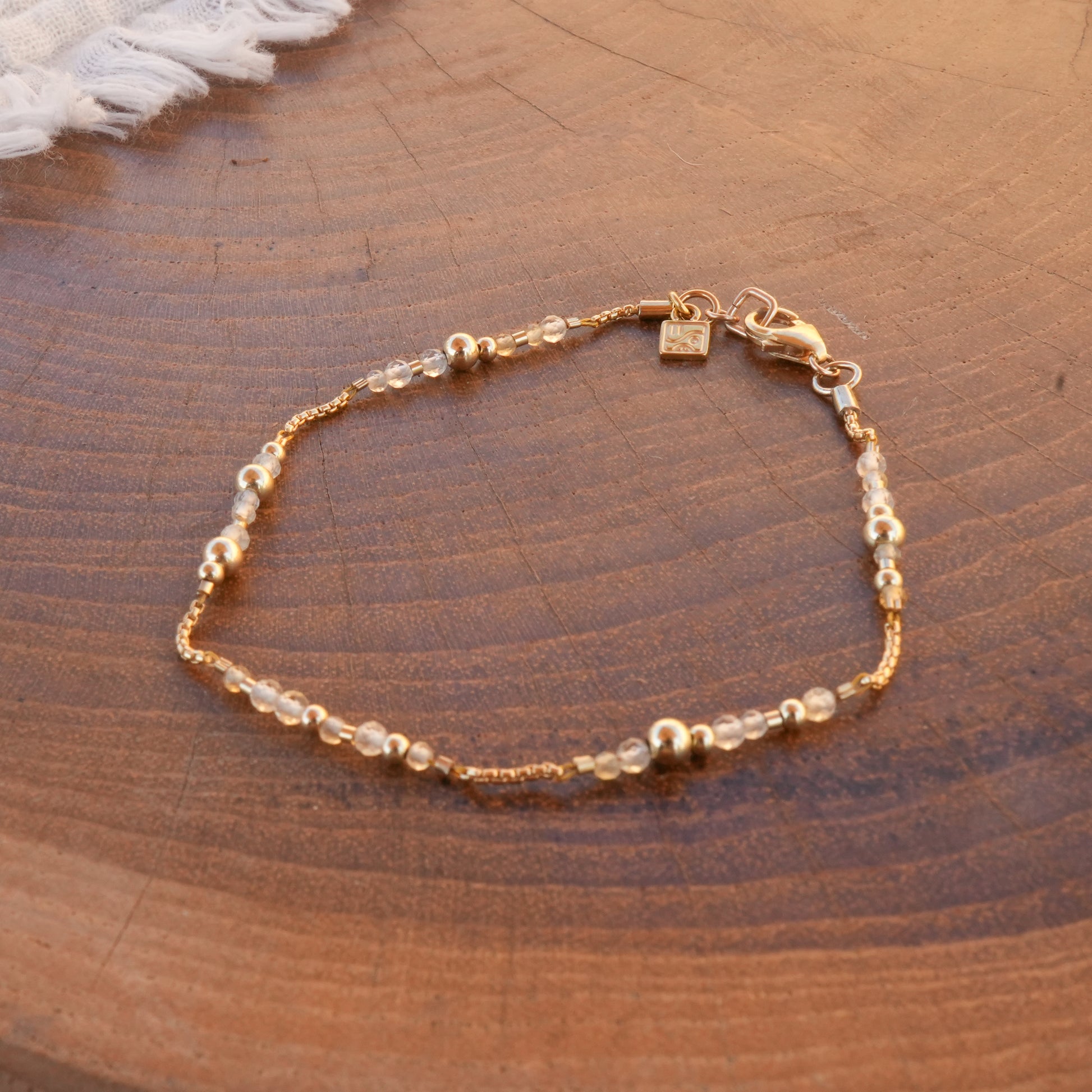 citrine and gold-filled beaded bracelet on a wooden table