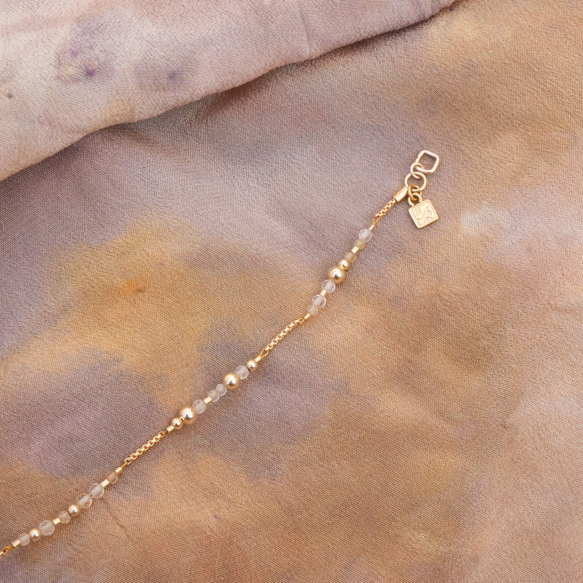 opened citrine and gold-filled beaded bracelet on a silk cloth