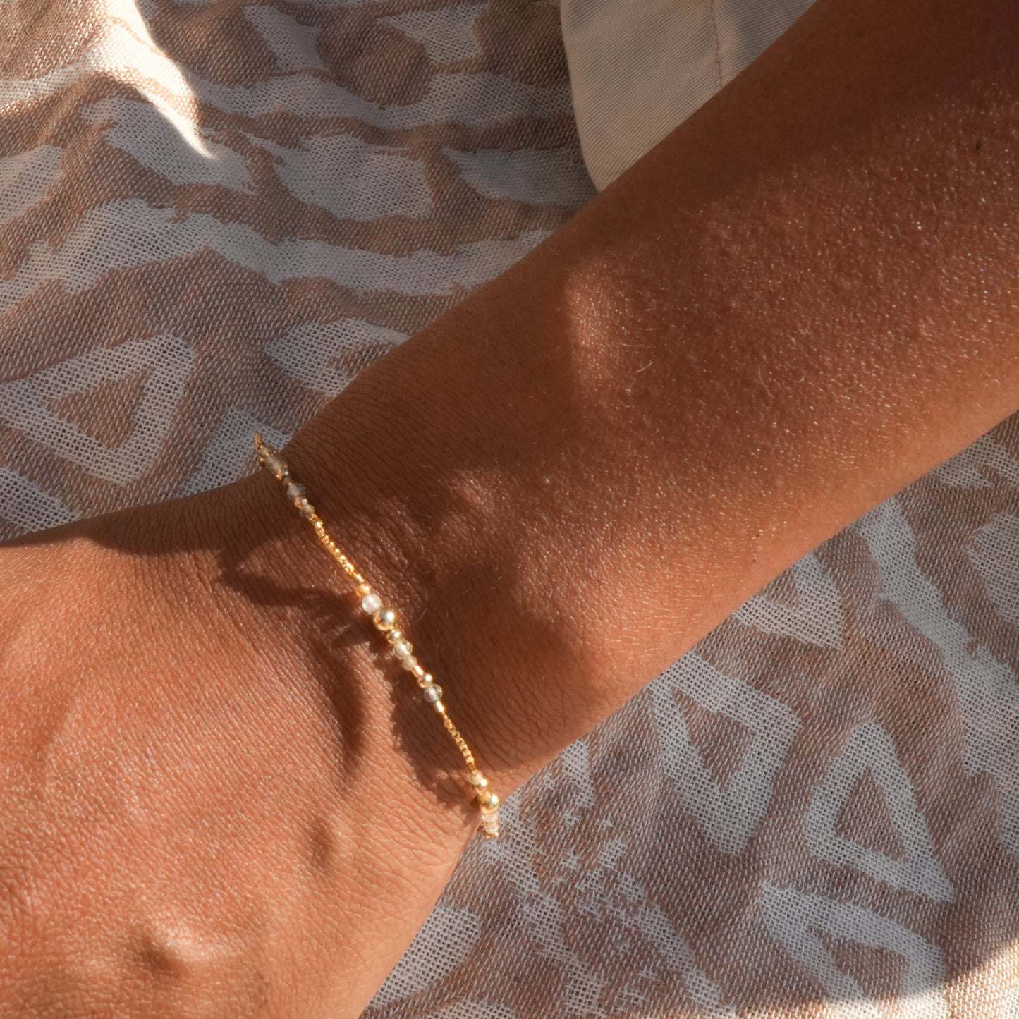 woman's wrist wearing a citrine and gold-filled beaded bracelet