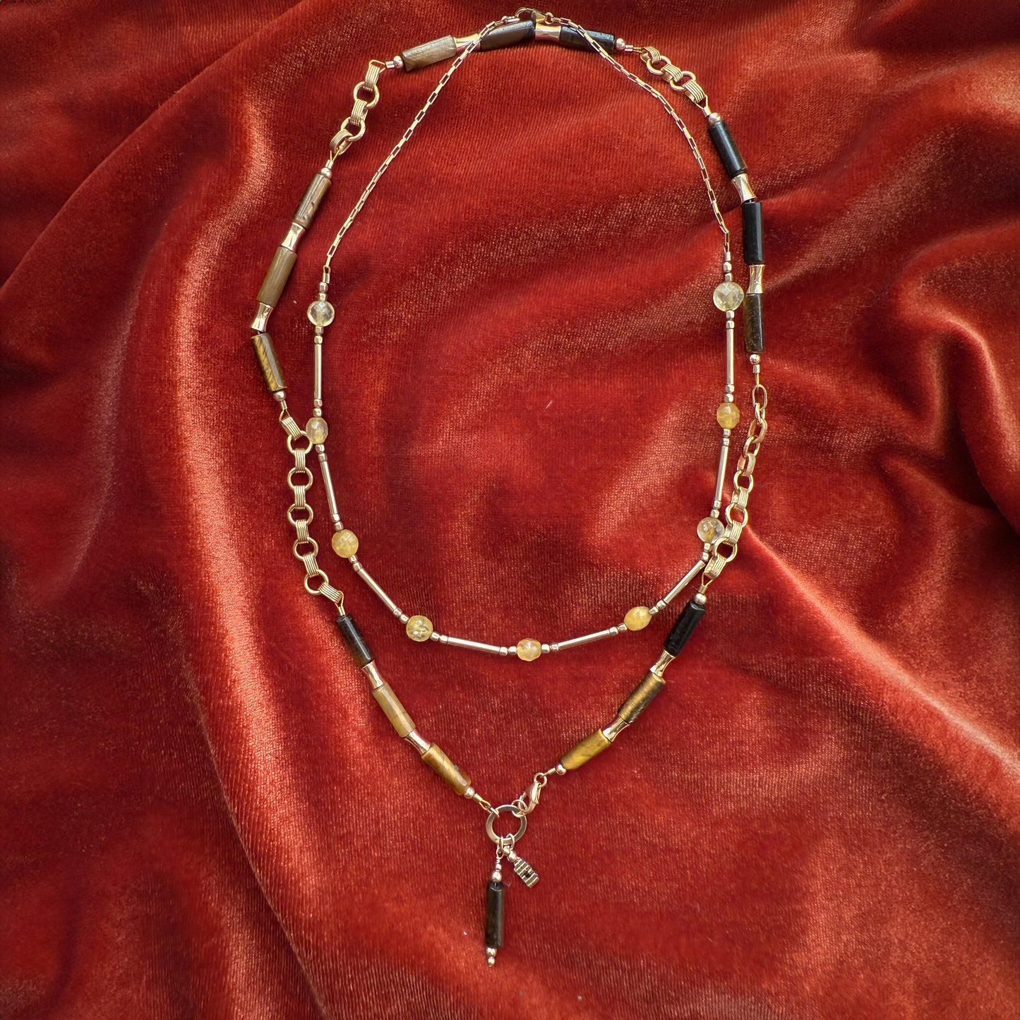 bundle of two beaded necklaces on a red cloth