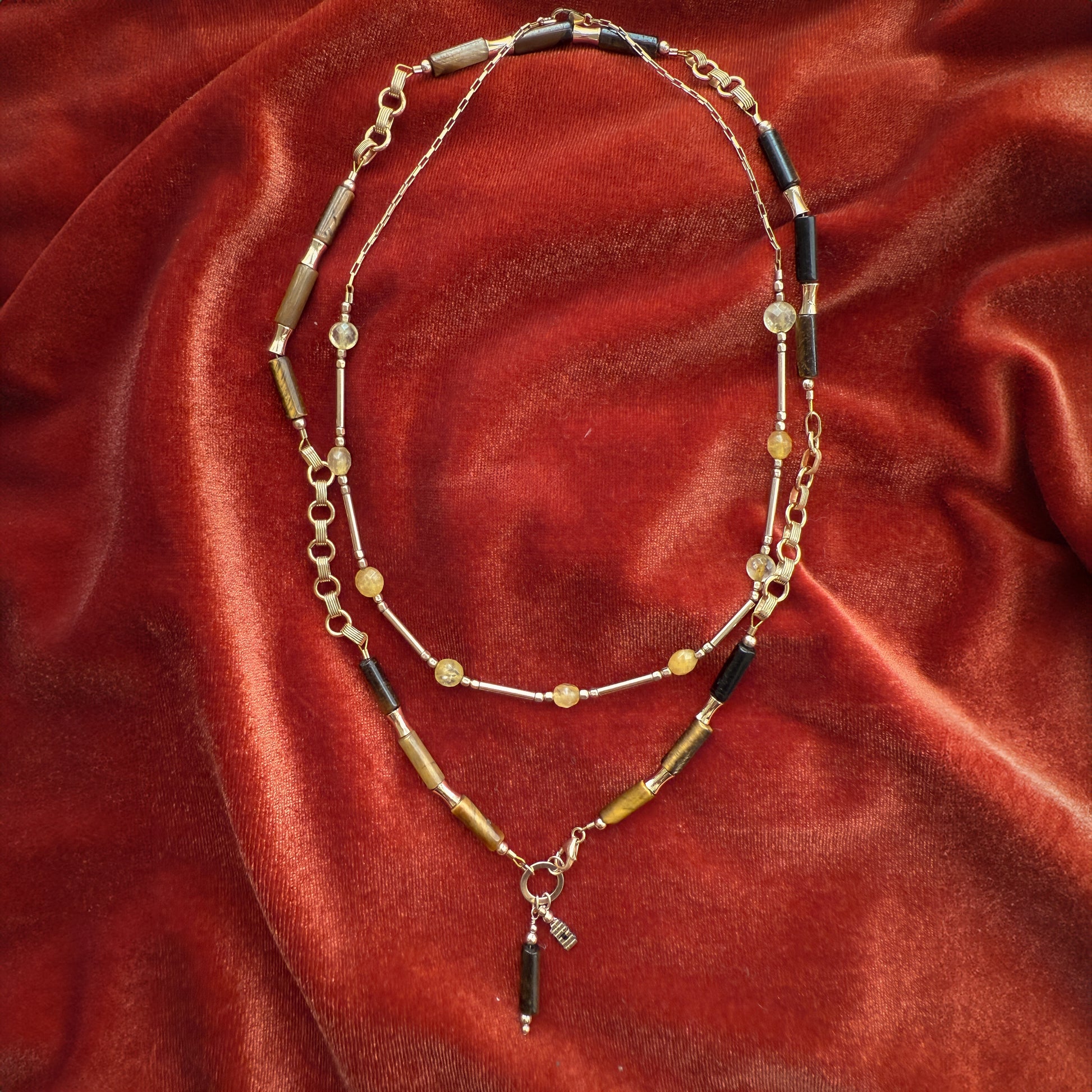 bundle of two beaded necklaces on a red cloth