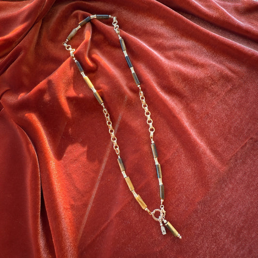 necklace with gold-filled beads, tiger's eye bamboo-shaped beads, and gold links with a stylish clasp and dangling accents