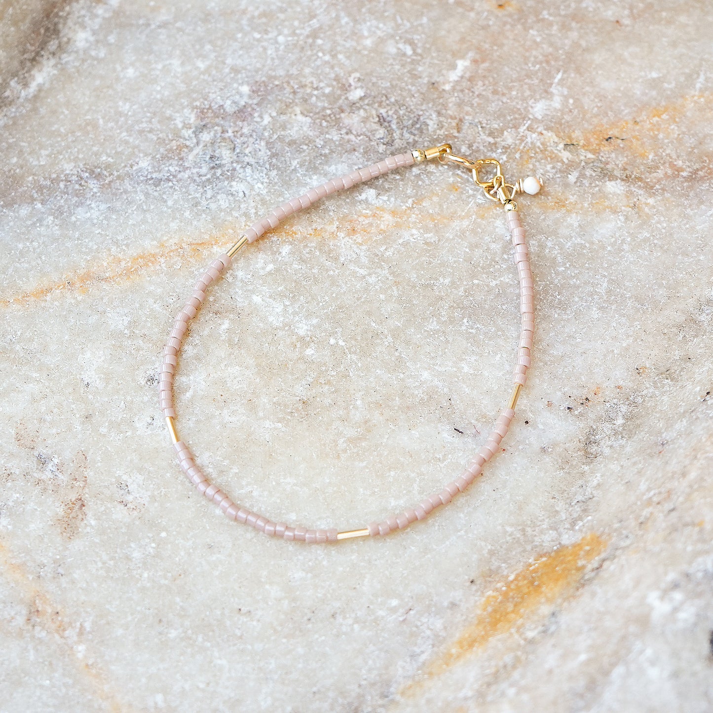 bracelet with Japanese glass seed beads on a marble surface