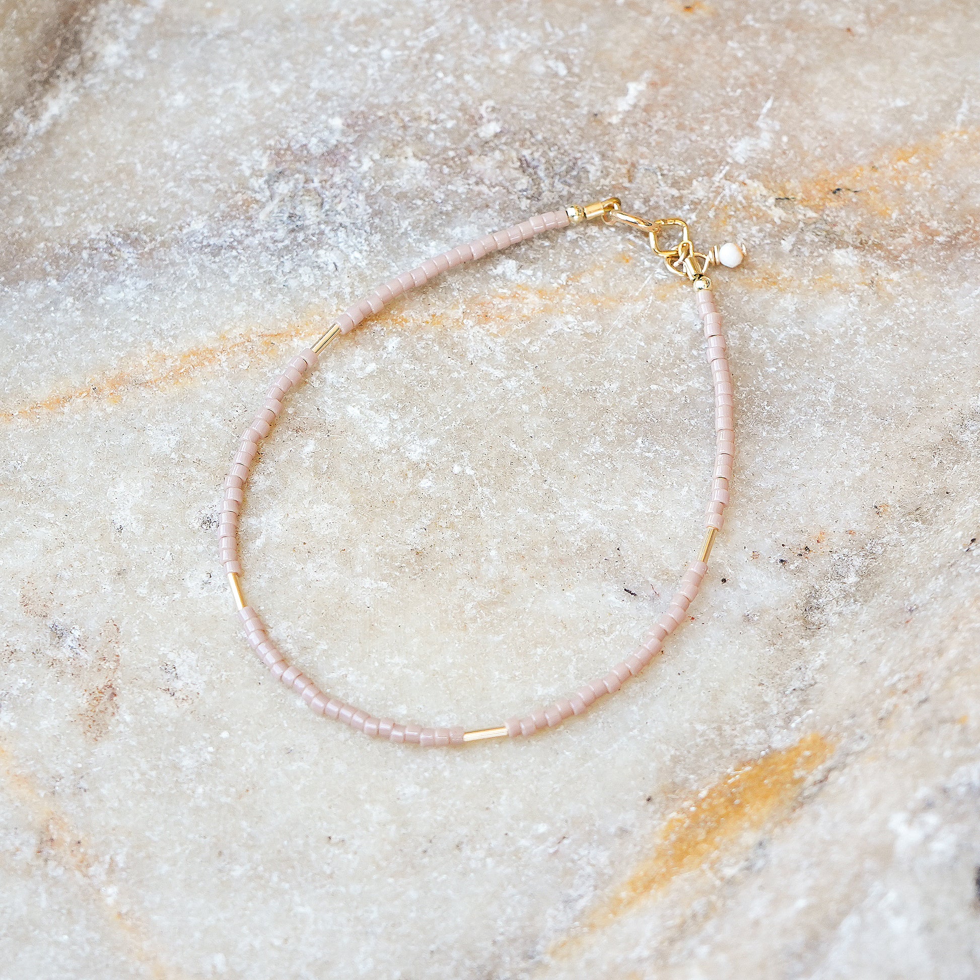 bracelet with Japanese glass seed beads on a marble surface