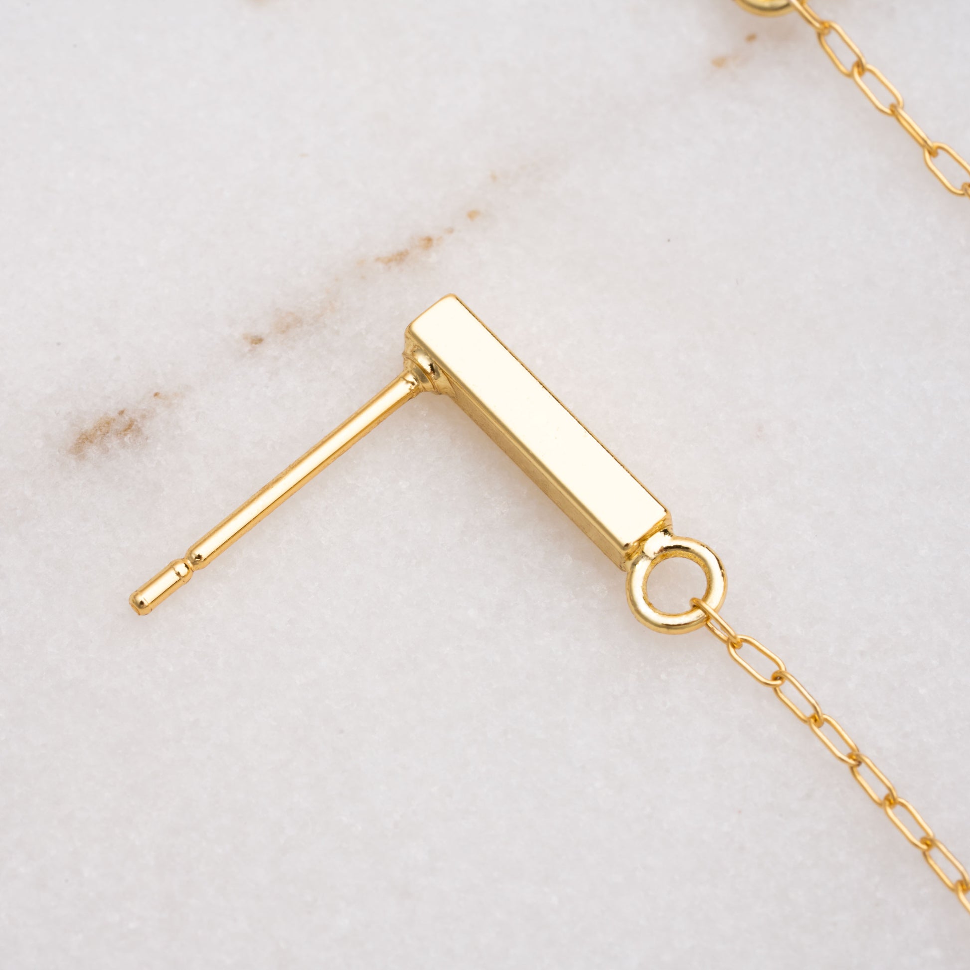 close-up view of a gold-filled vertical bar earring post