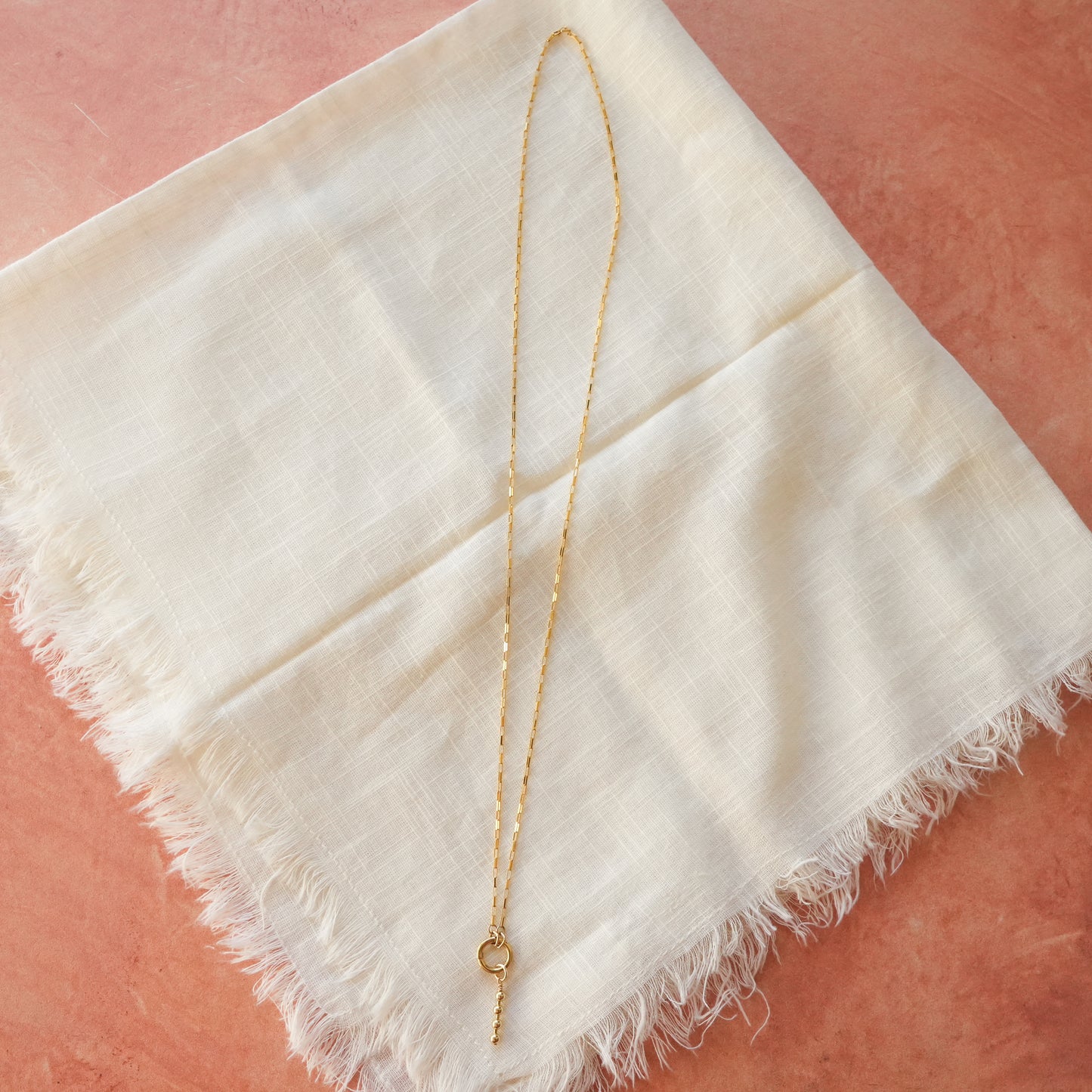 gold-filled chain necklace with circle front clasp and dangling gold-filled beaded accent