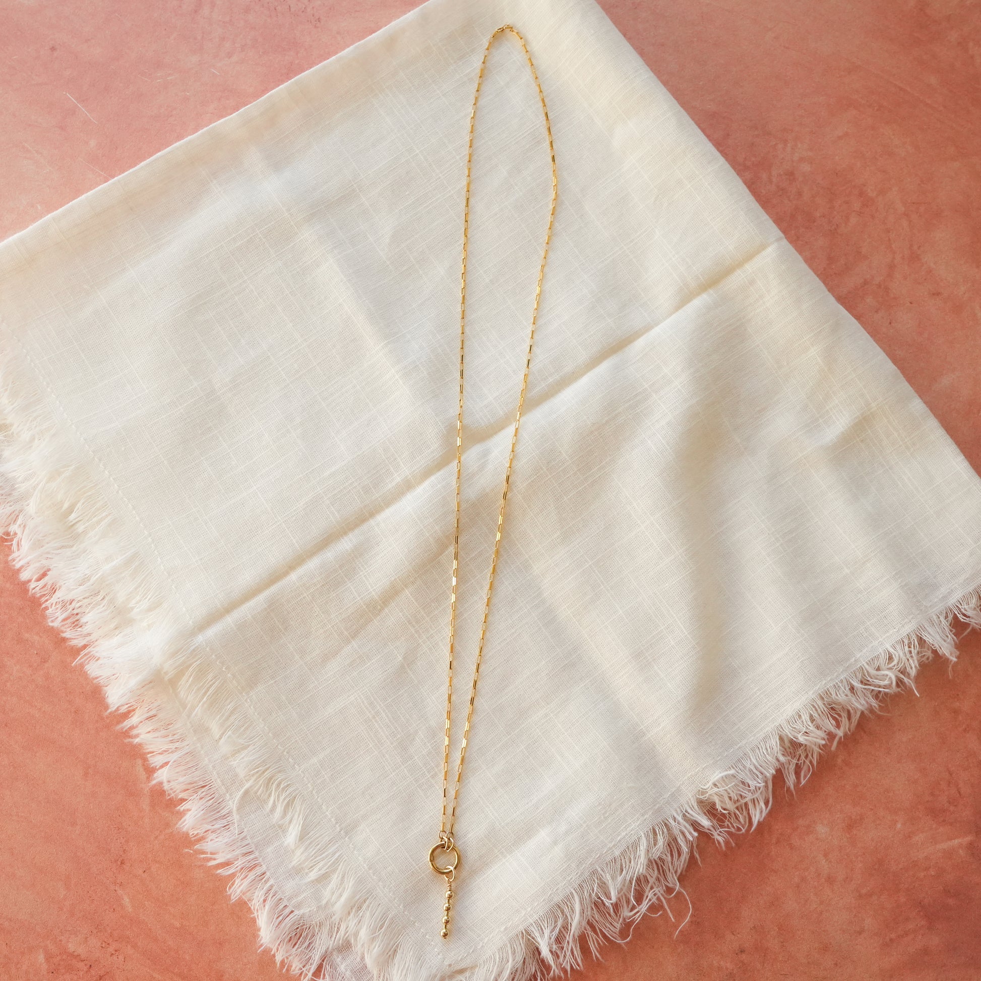 gold-filled chain necklace with circle front clasp and dangling gold-filled beaded accent