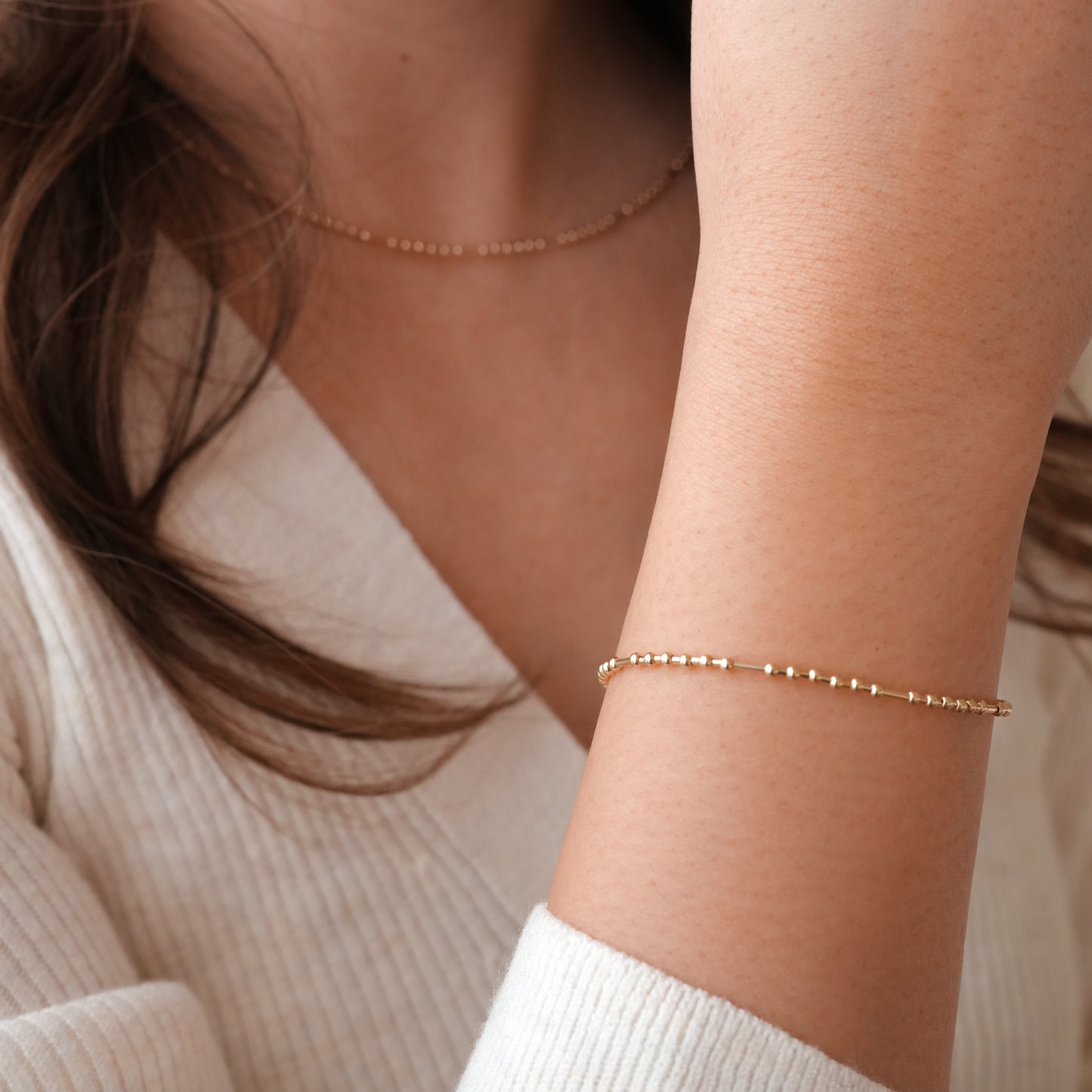 woman's wrist wearing gold-fill bead bracelet