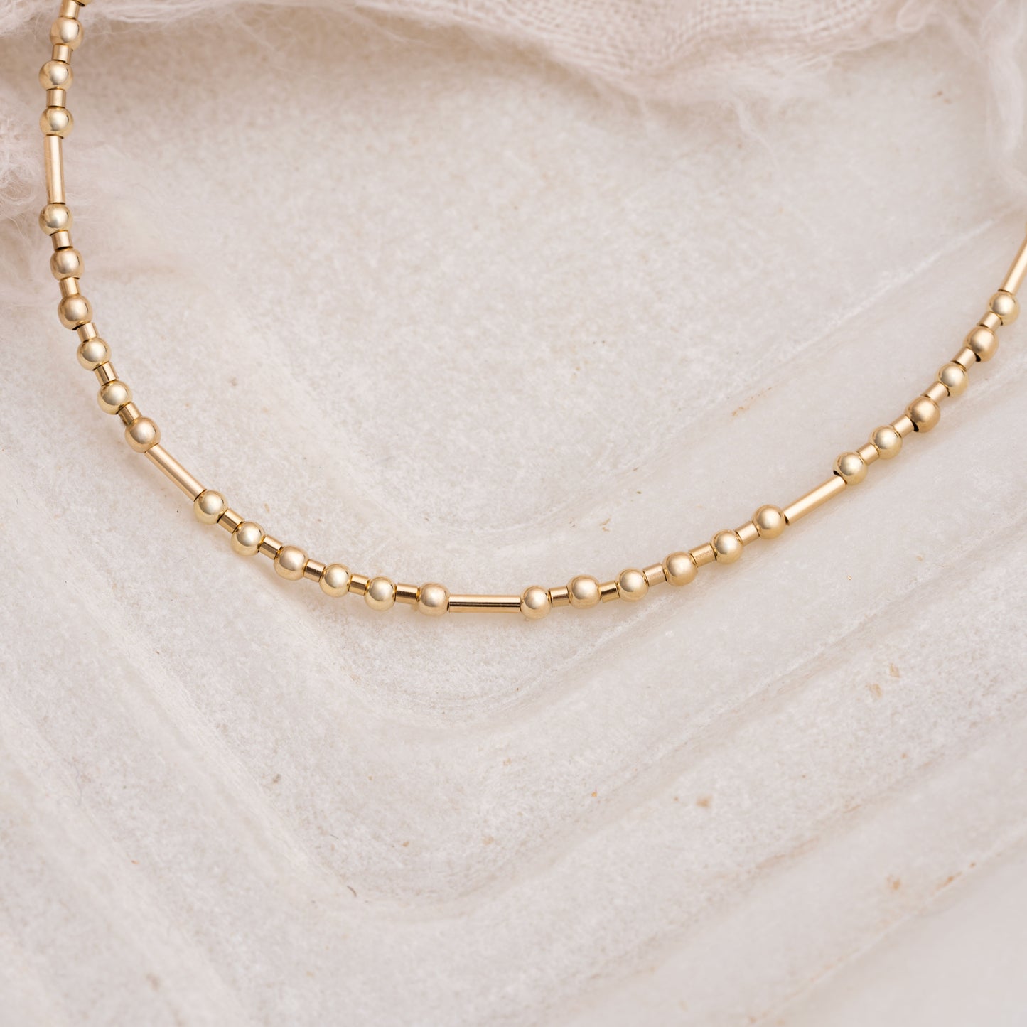 close up view of gold fill beads on a necklace
