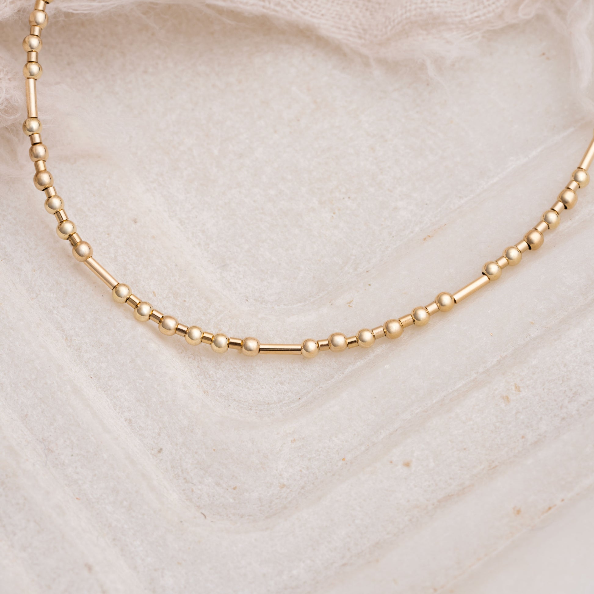 close up view of gold fill beads on a necklace
