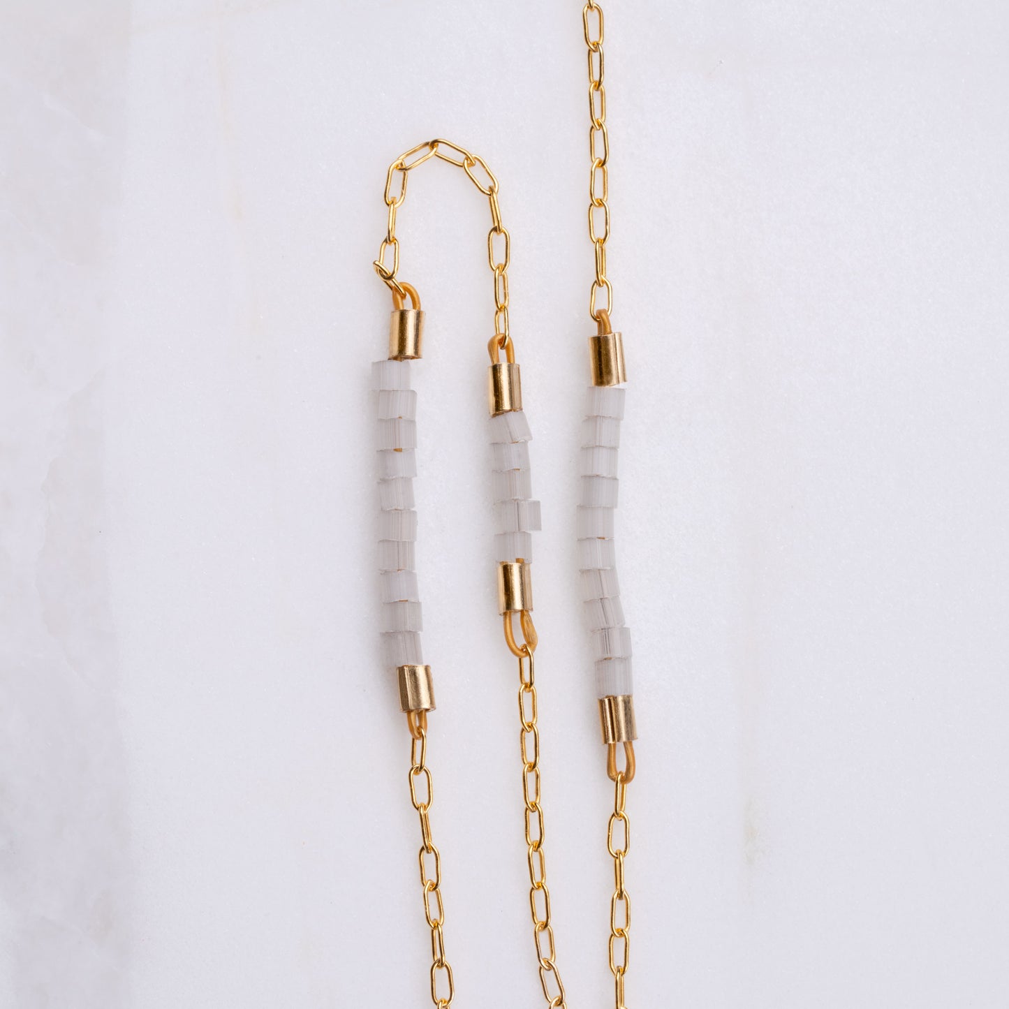 close up view of Miyuki glass beads on a gold-fill chain