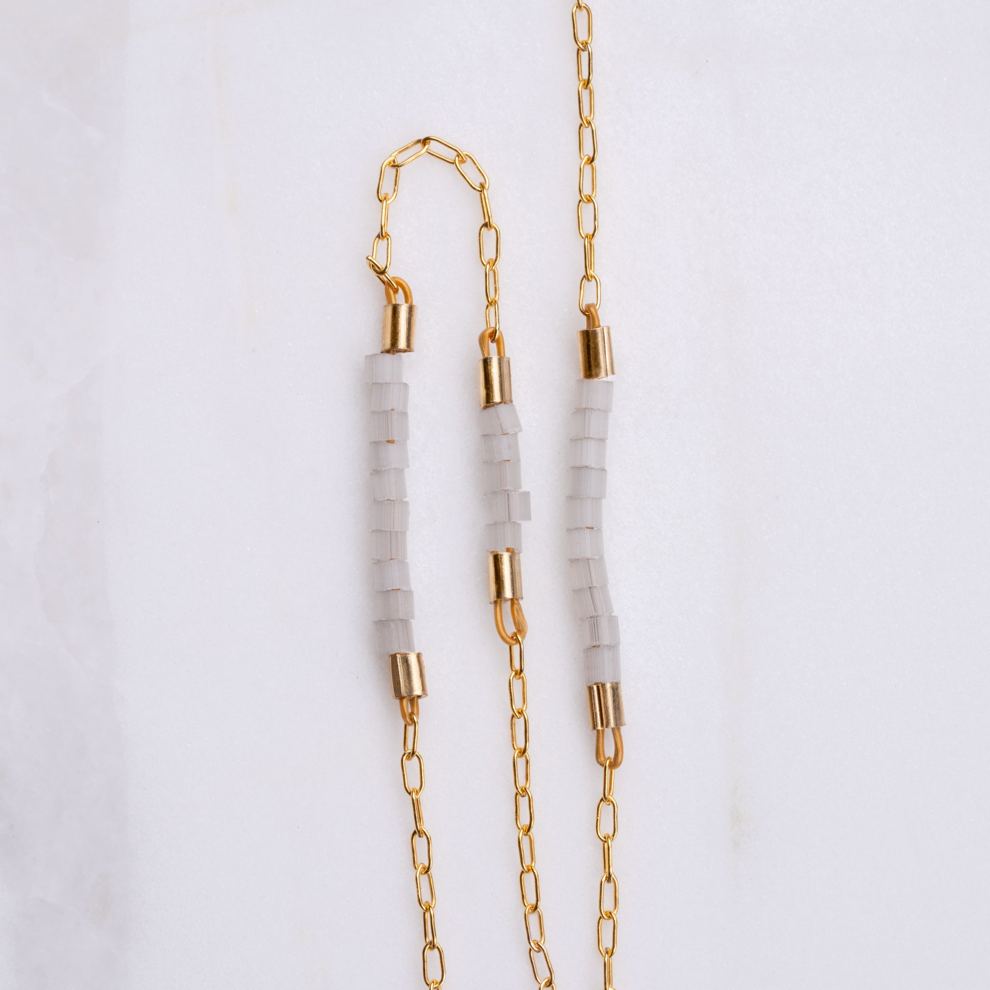 close up view of Miyuki glass beads on a gold-fill chain
