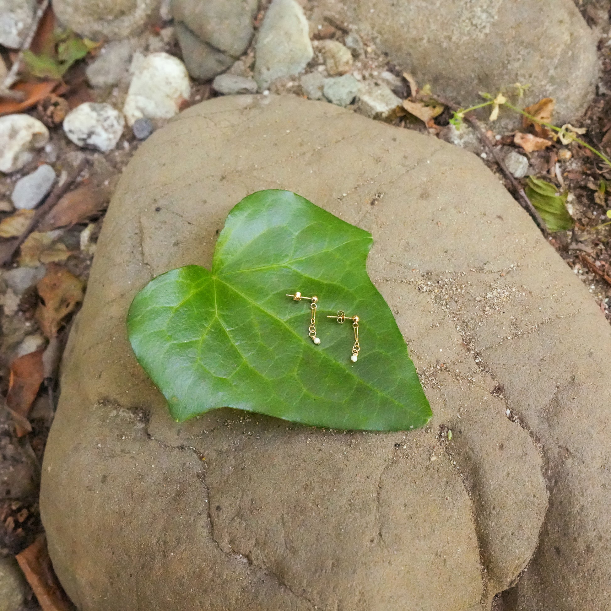earrings with australian opal and gold-fill chain, gold fill posts on a leaf