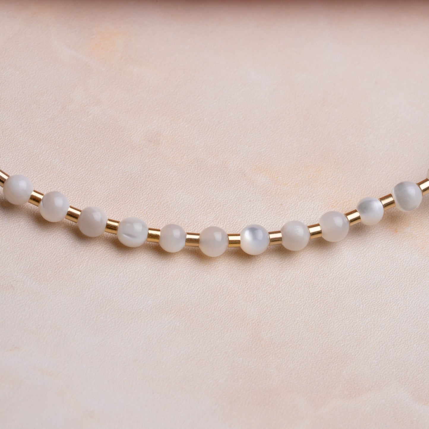 close up view of mother of pearl beads on a necklace