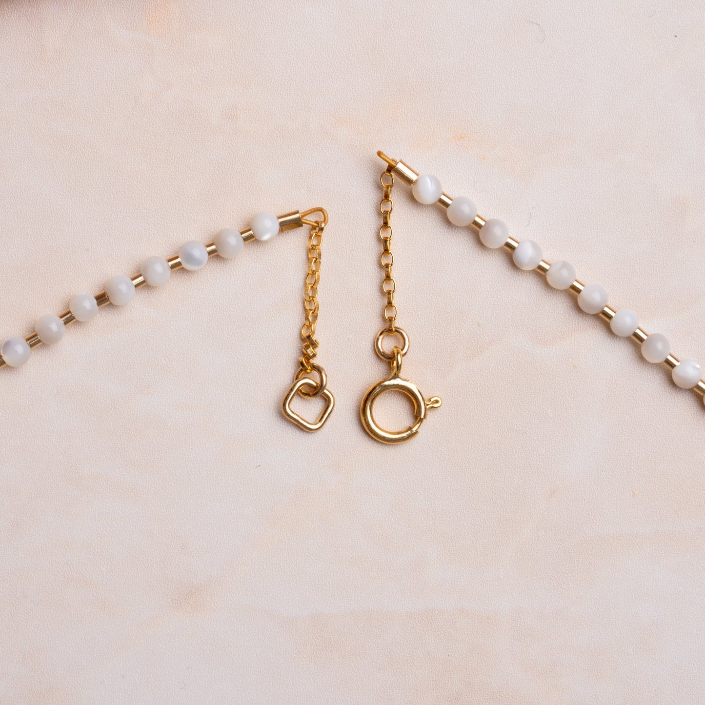 gold-fill clasp on a necklace with mother of pearl