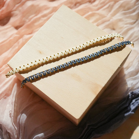 pair of bracelets with Japanese glass beads in white and blue-gray with gold-fill accent beads