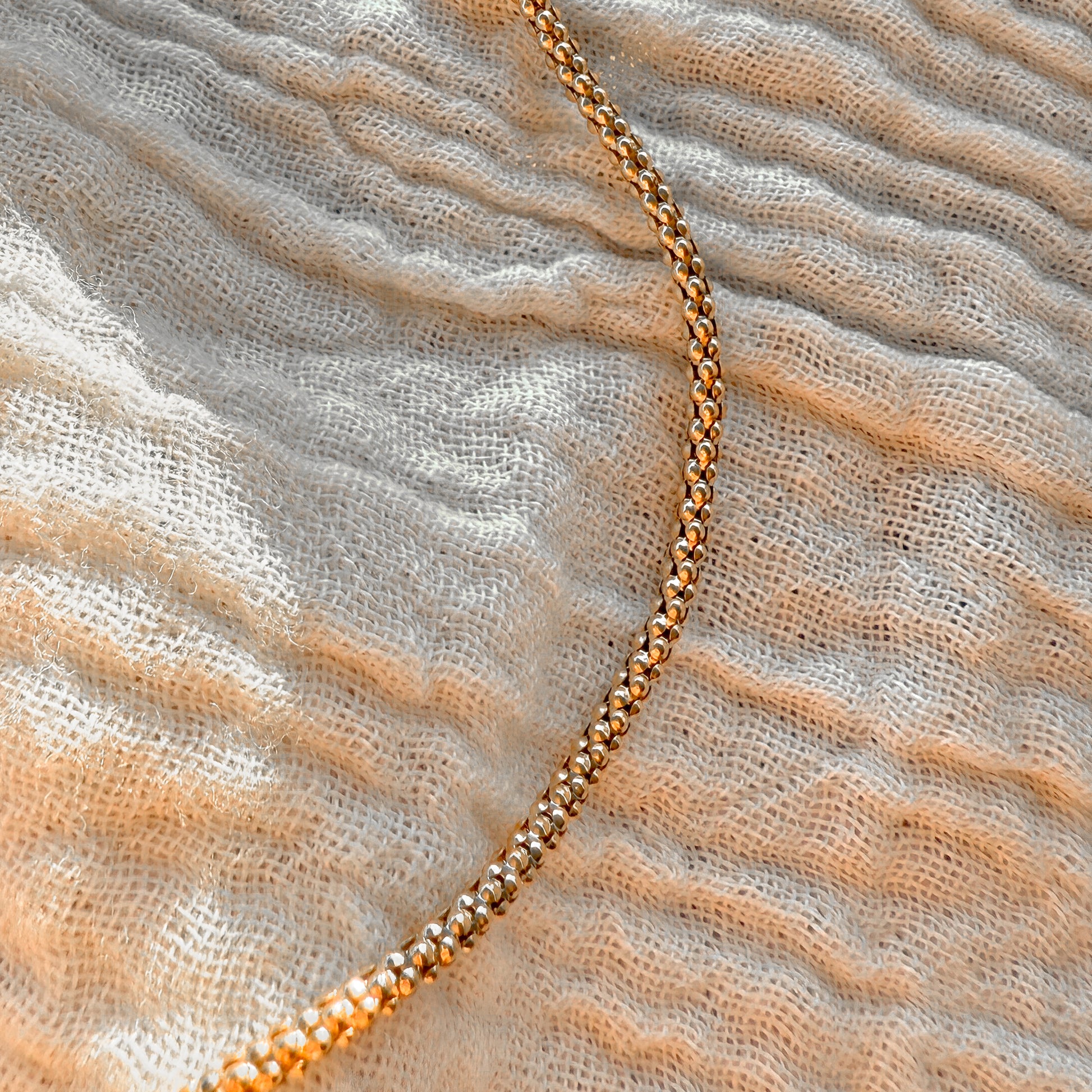 close up view of gold-filled popcorn chain necklace