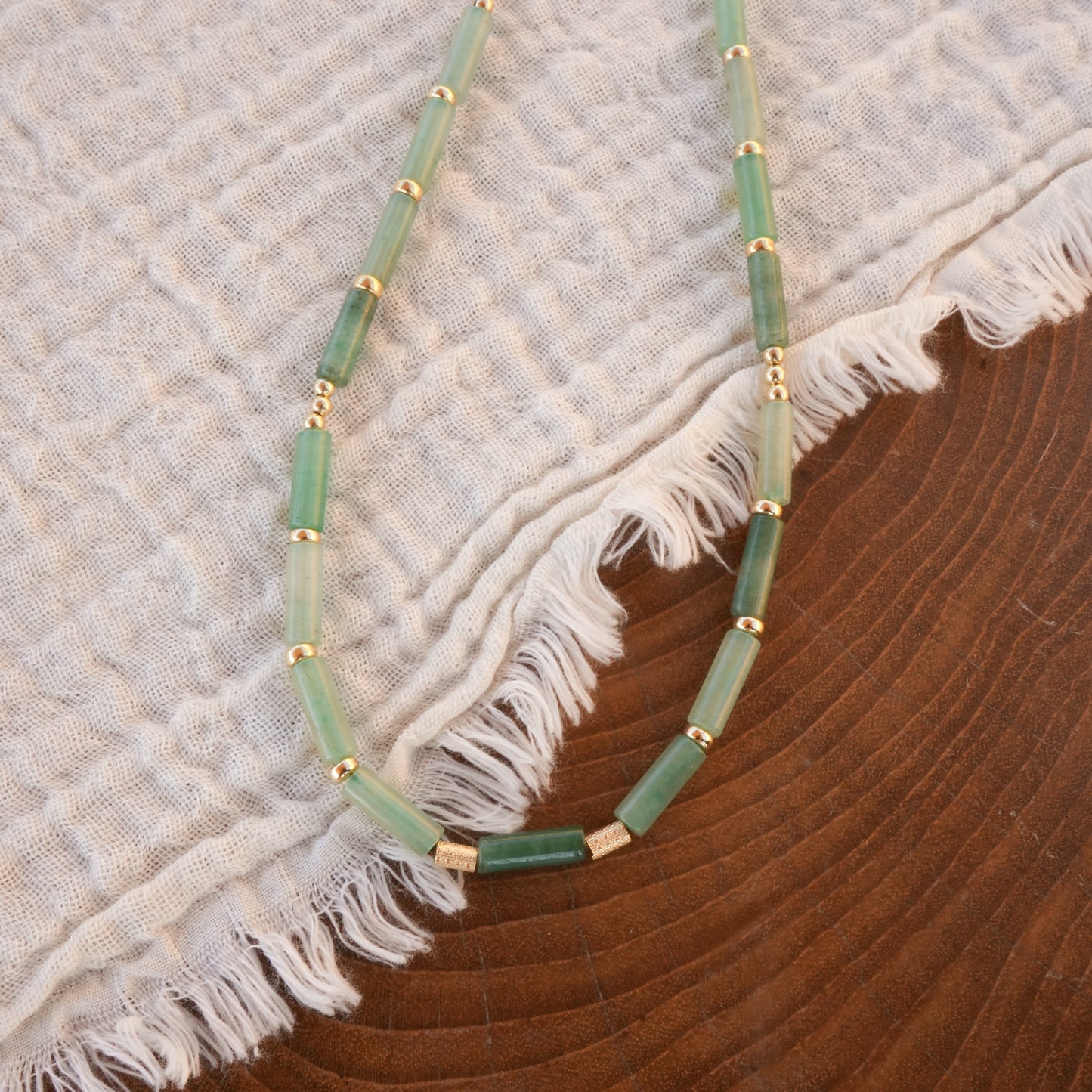necklace with Aventurine tube beads and gold-filled beads on a white cloth