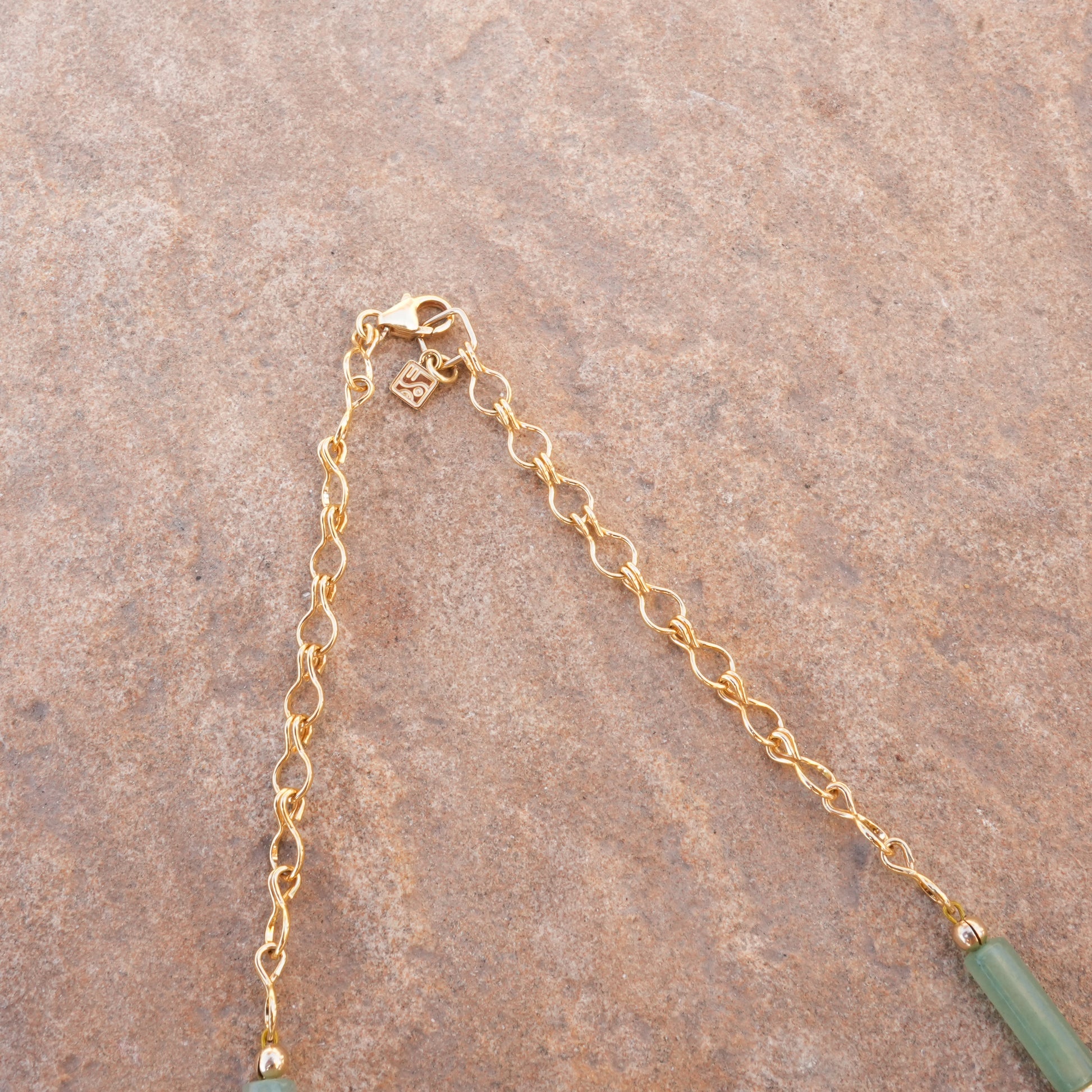 gold-filled chain and clasp with so niice logo charm on a necklace