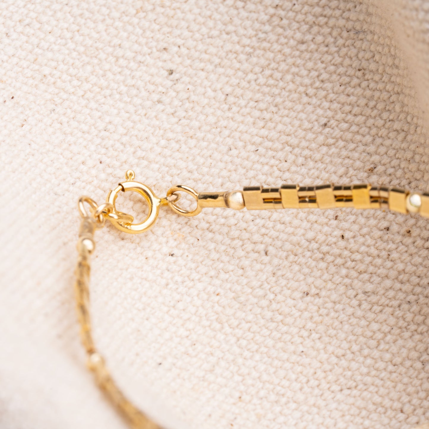 detailed view of clasp and beads on a patterned gold-filled bead bracelet