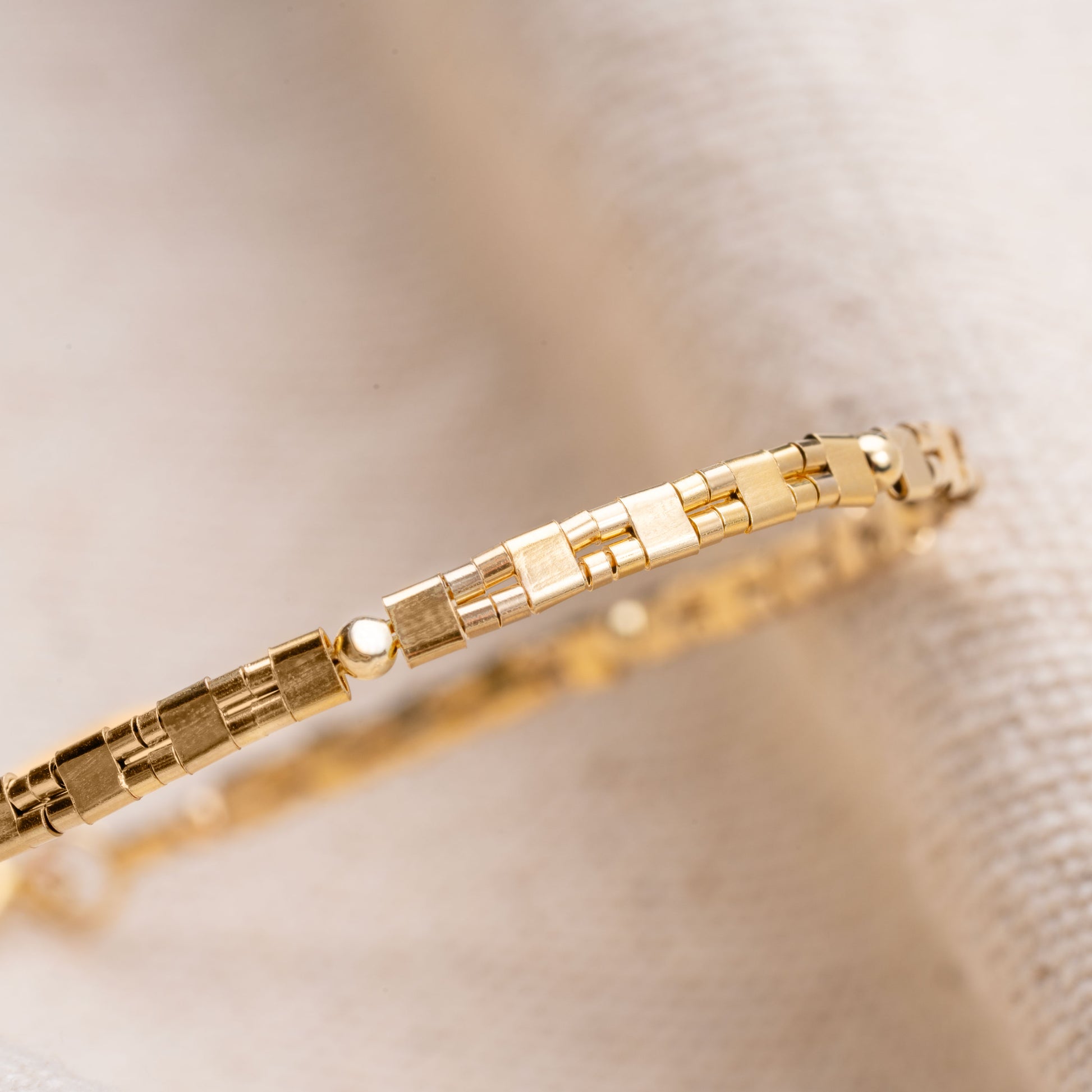 close up view of patterned gold-filled bead bracelet