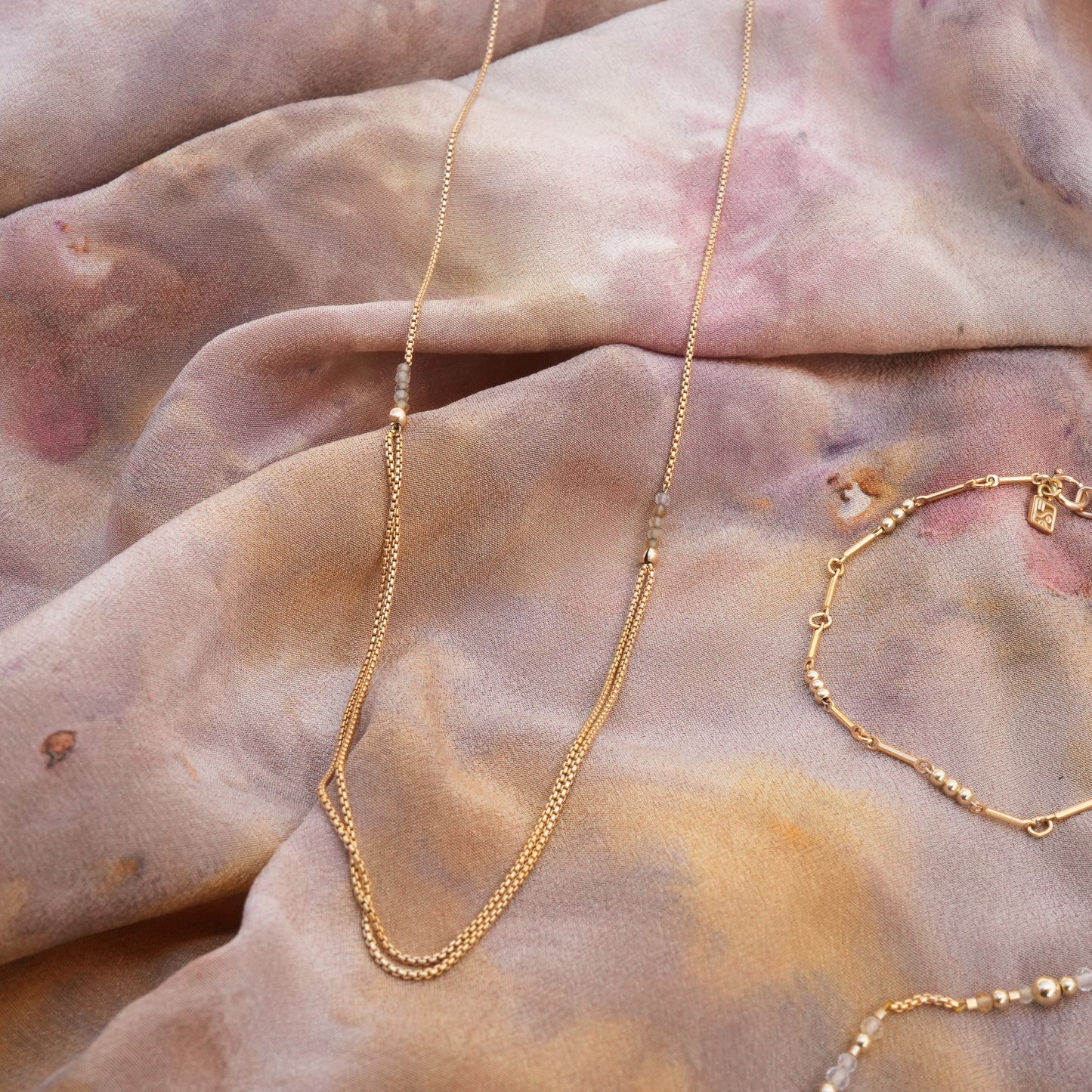 necklace with gold-fill chain and citrine faceted stones and gold-filled beaded bracelet on a scarf