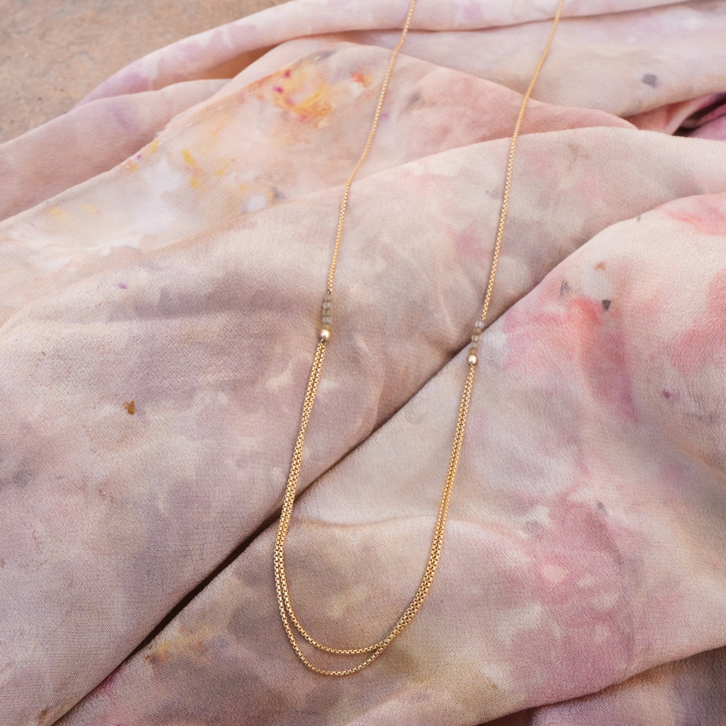 necklace with gold-fill chain and citrine faceted stones on a scarf