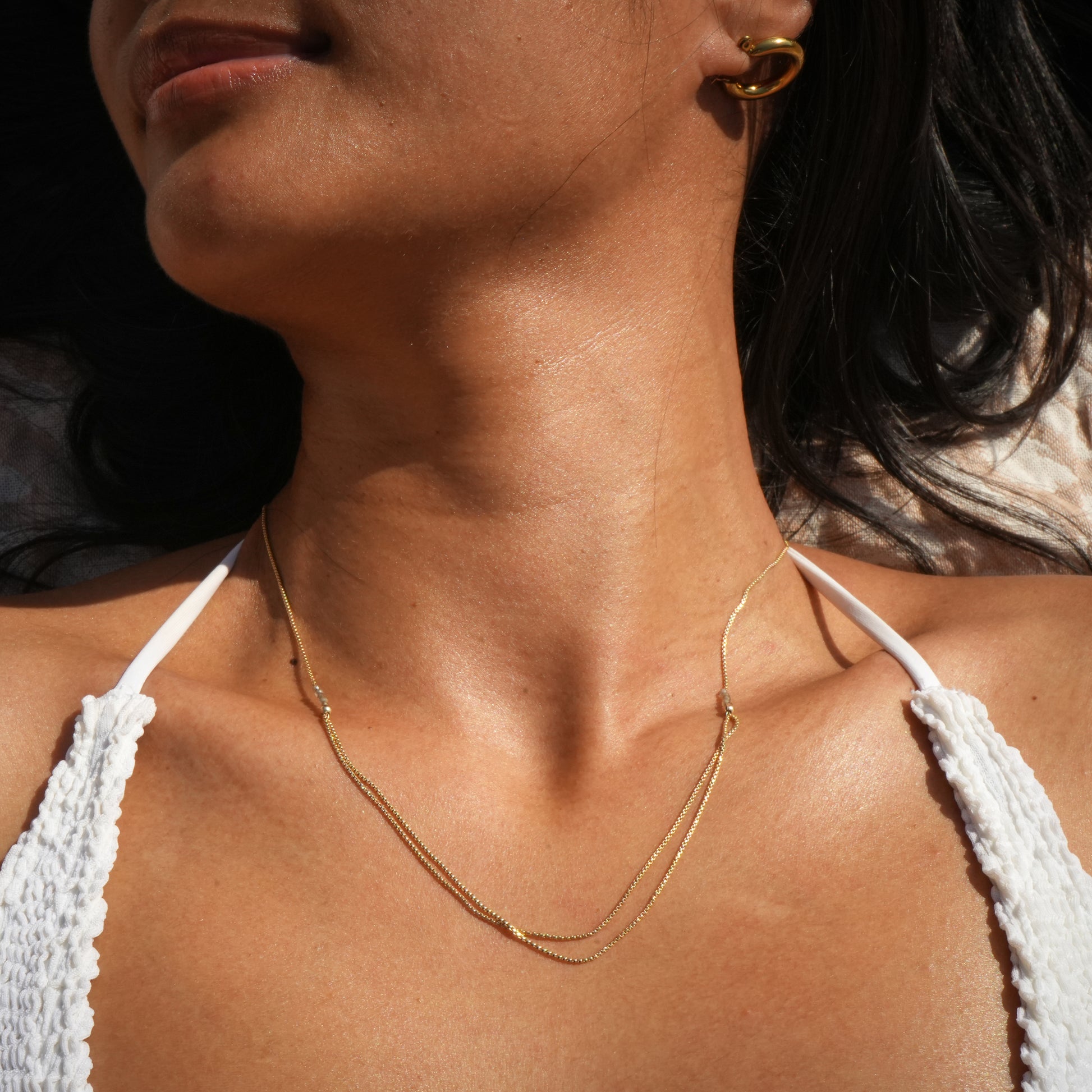 woman wearing necklace with gold-fill chain and citrine faceted stones