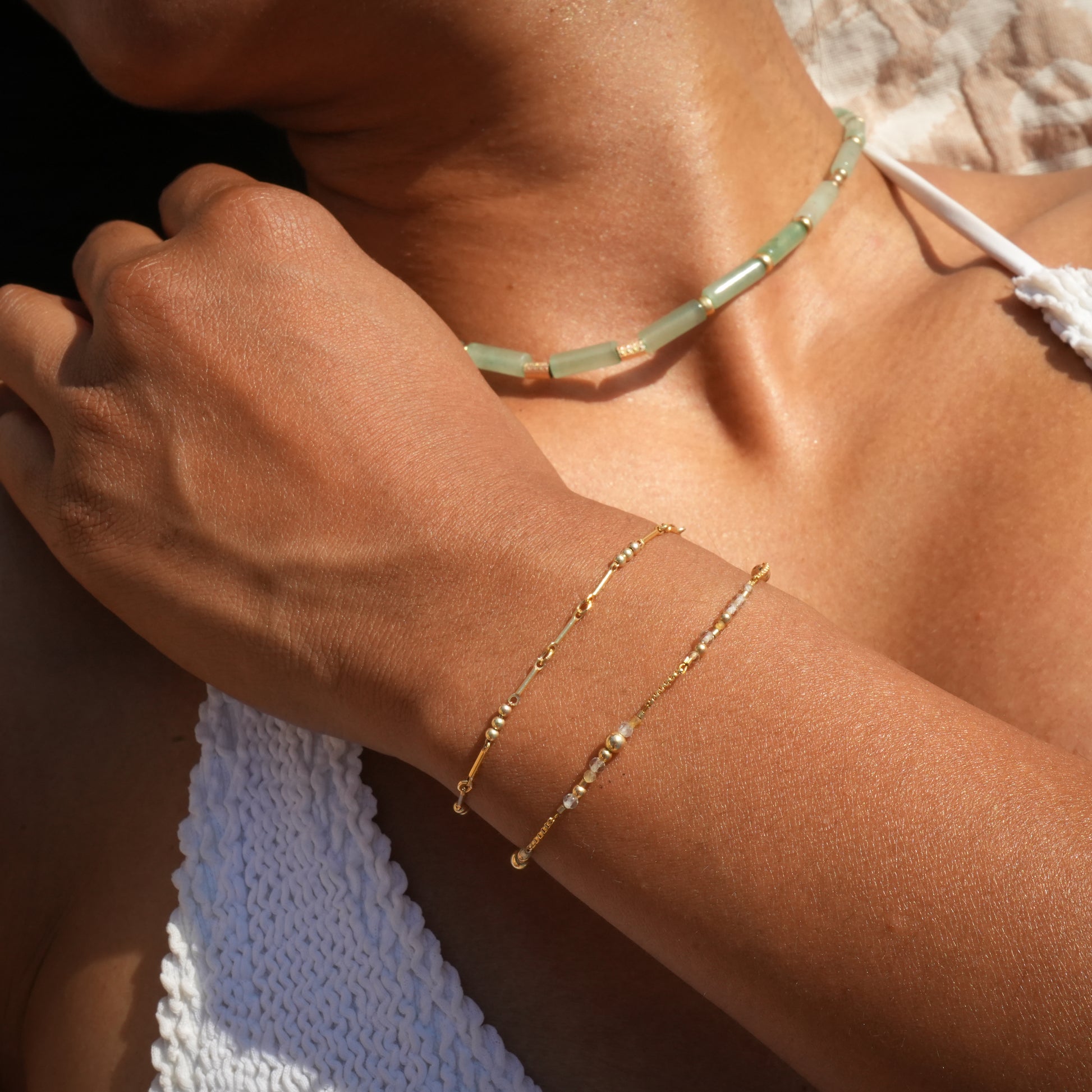 woman wearing a beaded necklace and two bracelets