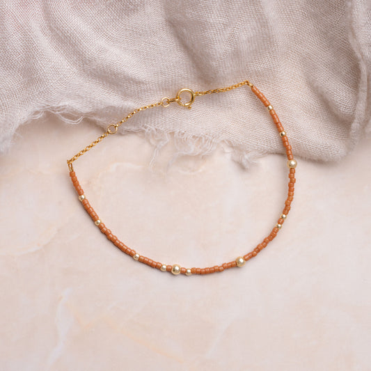 brown miyuki glass bead bracelet on a white cloth