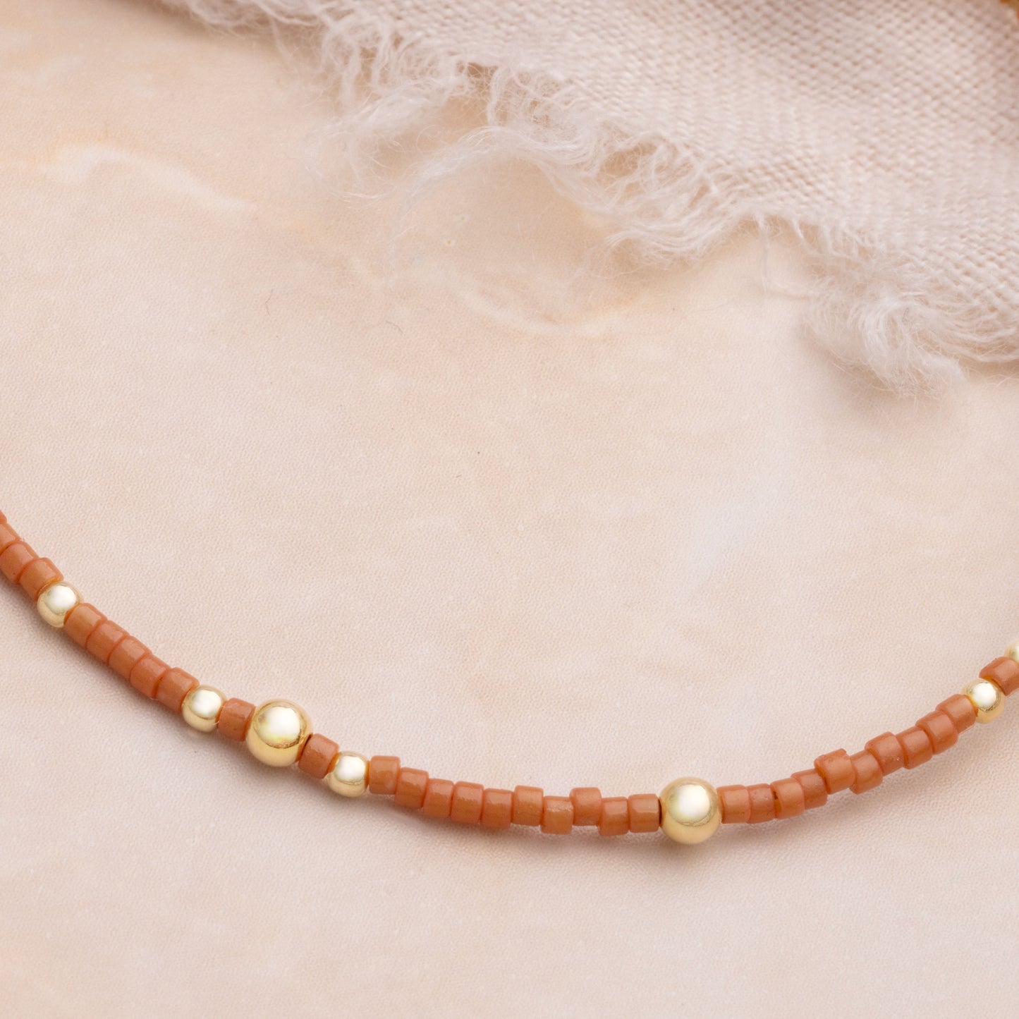 close up view of brown miyuki glass bead bracelet