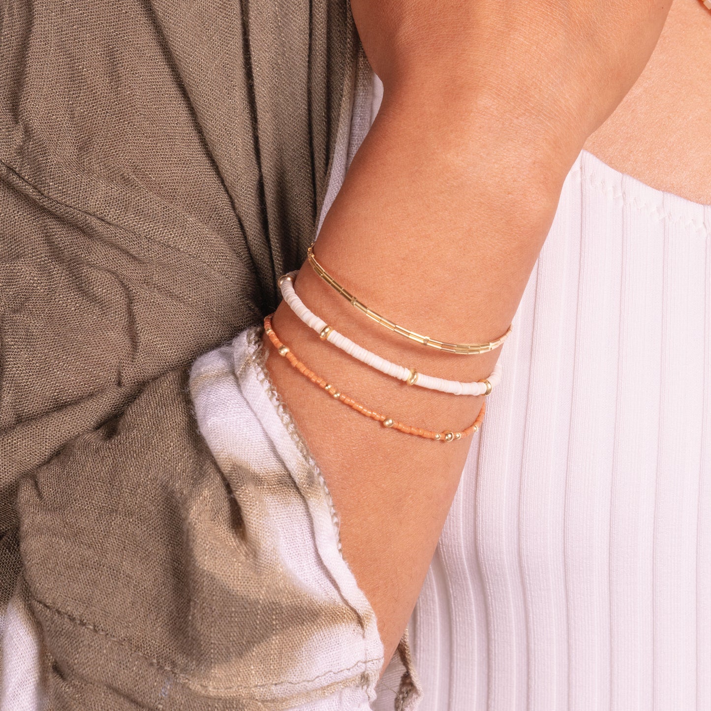 woman's wrist with three bracelets