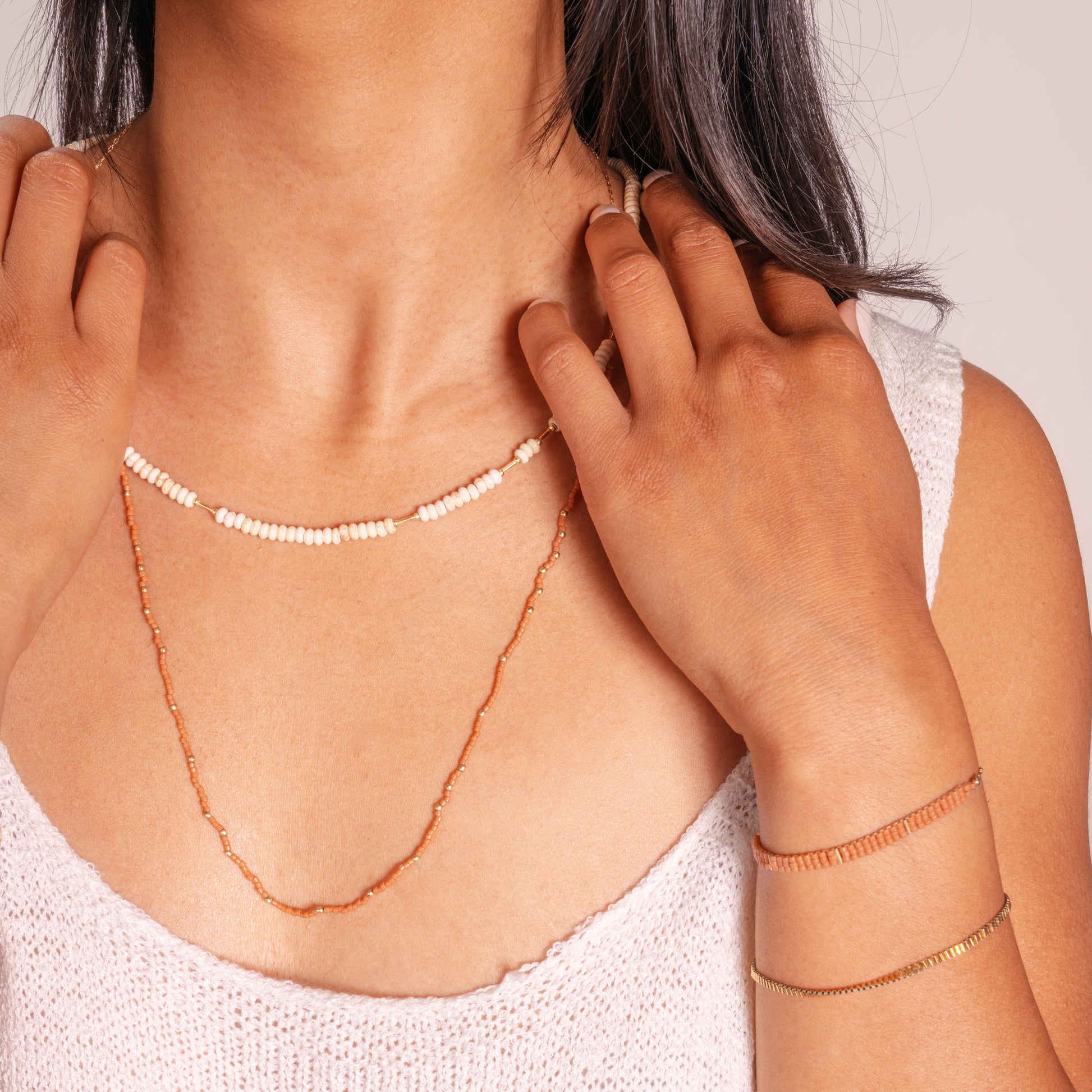 woman wearing beaded necklaces and bracelets