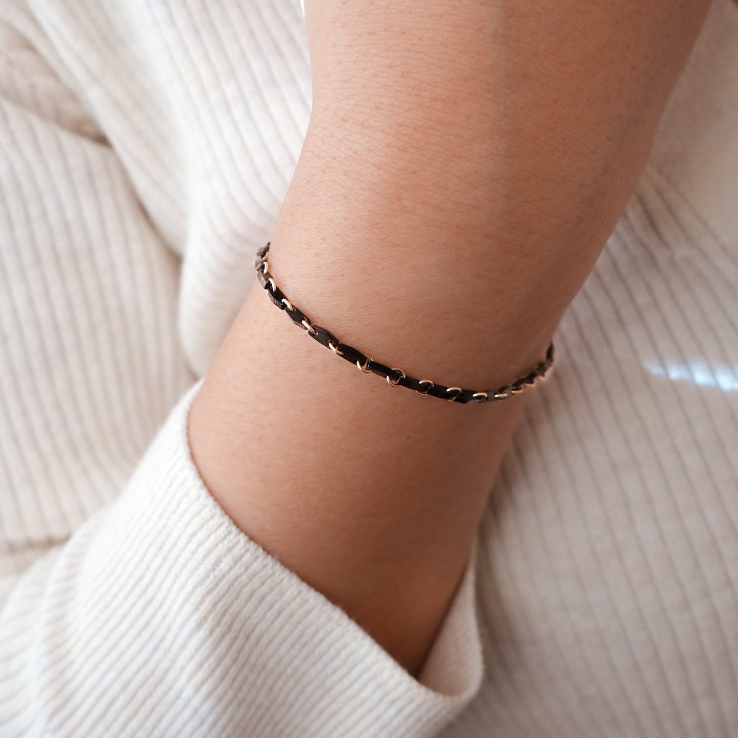 woman's wrist with black beaded bracelet