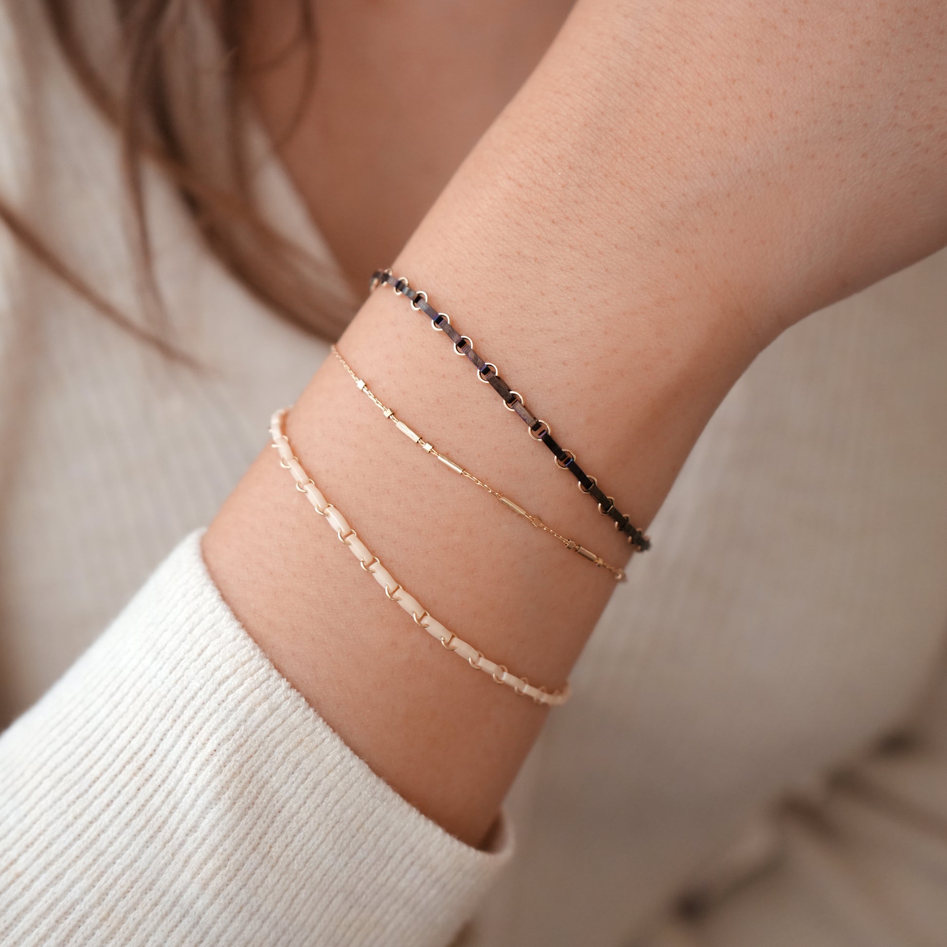 woman's wrist with 3 bracelets