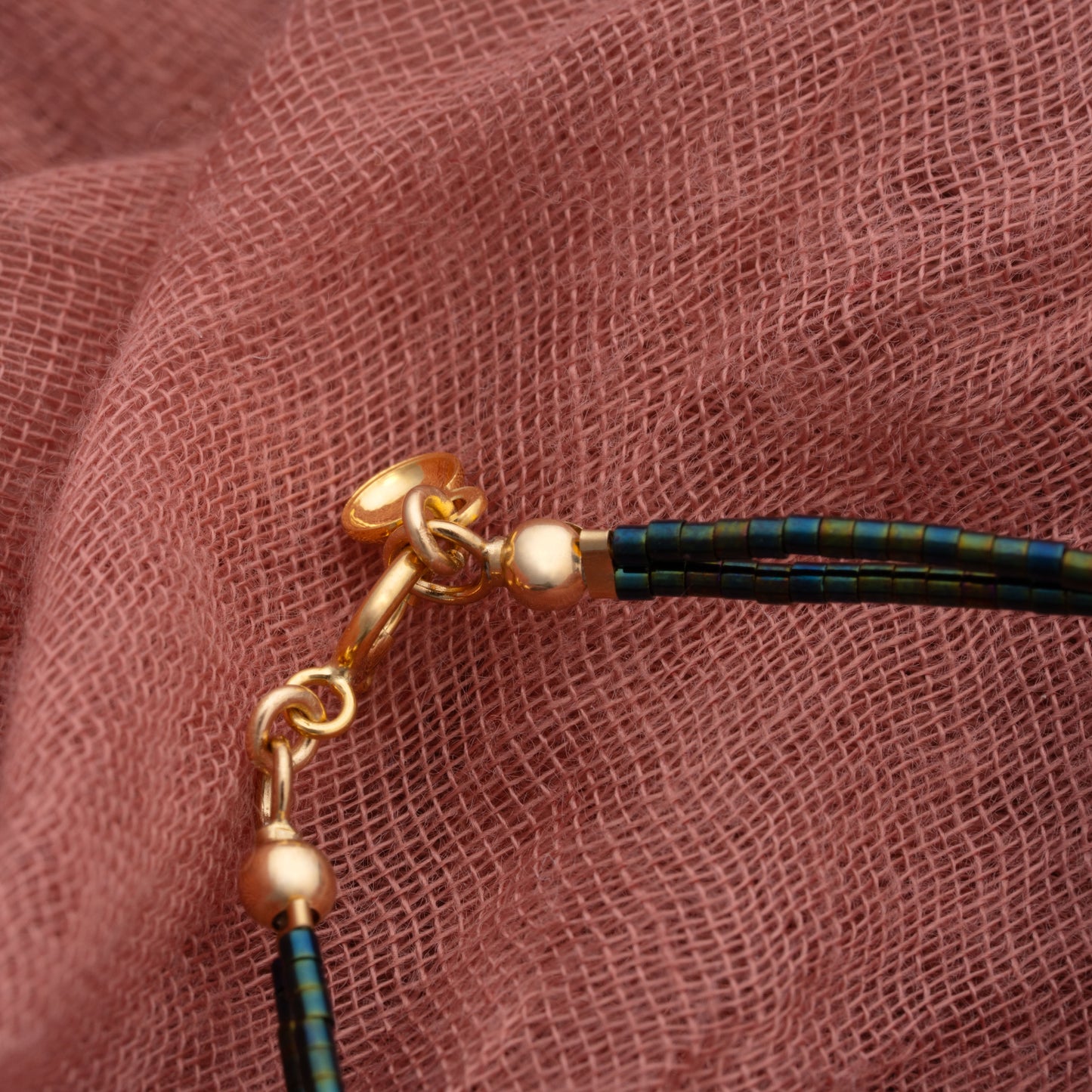 clasp on a double strand bracelet with iridescent dark teal and green miyuki beads