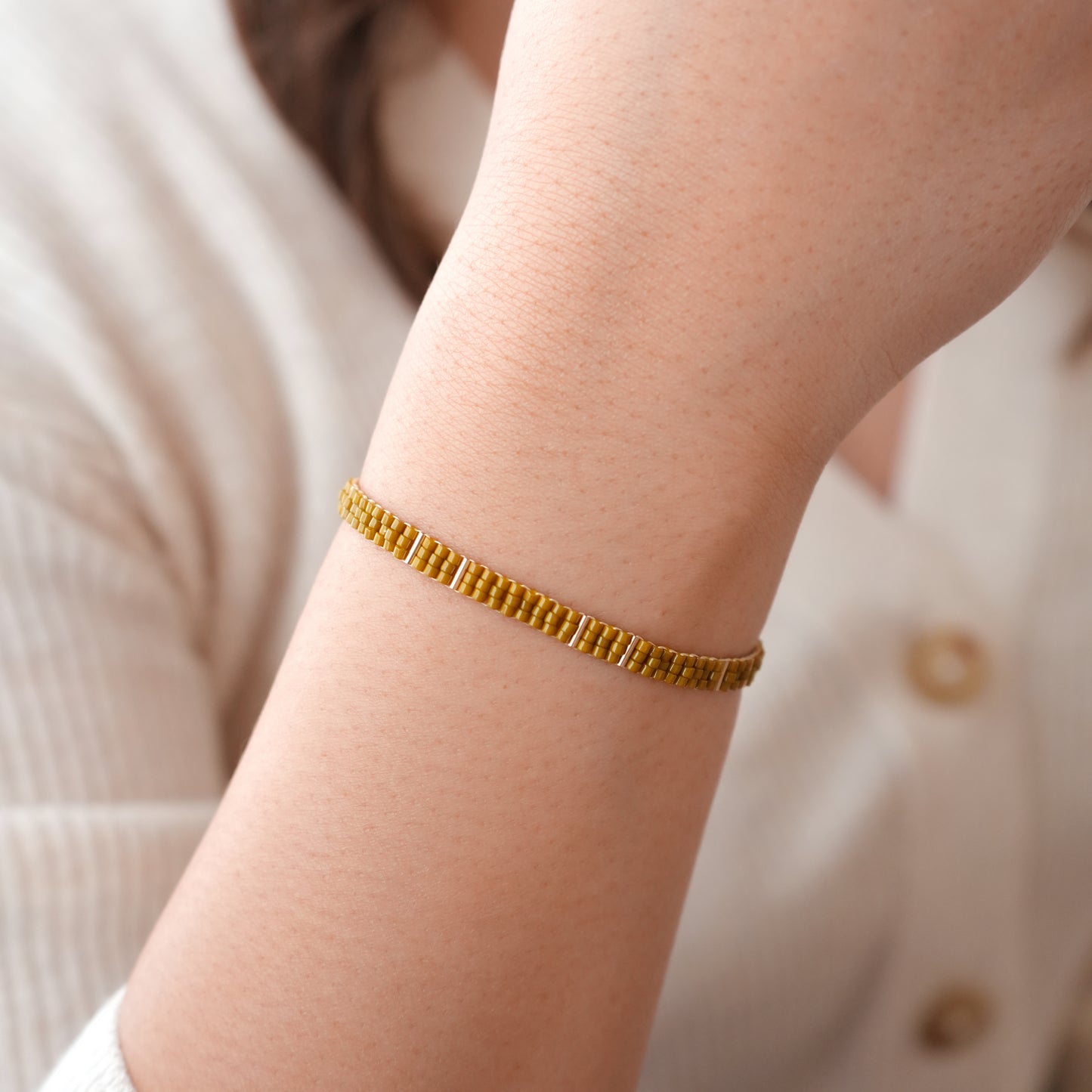woman's wrist with chartreuse miyuki glass bead bracelet with gold-fill chain